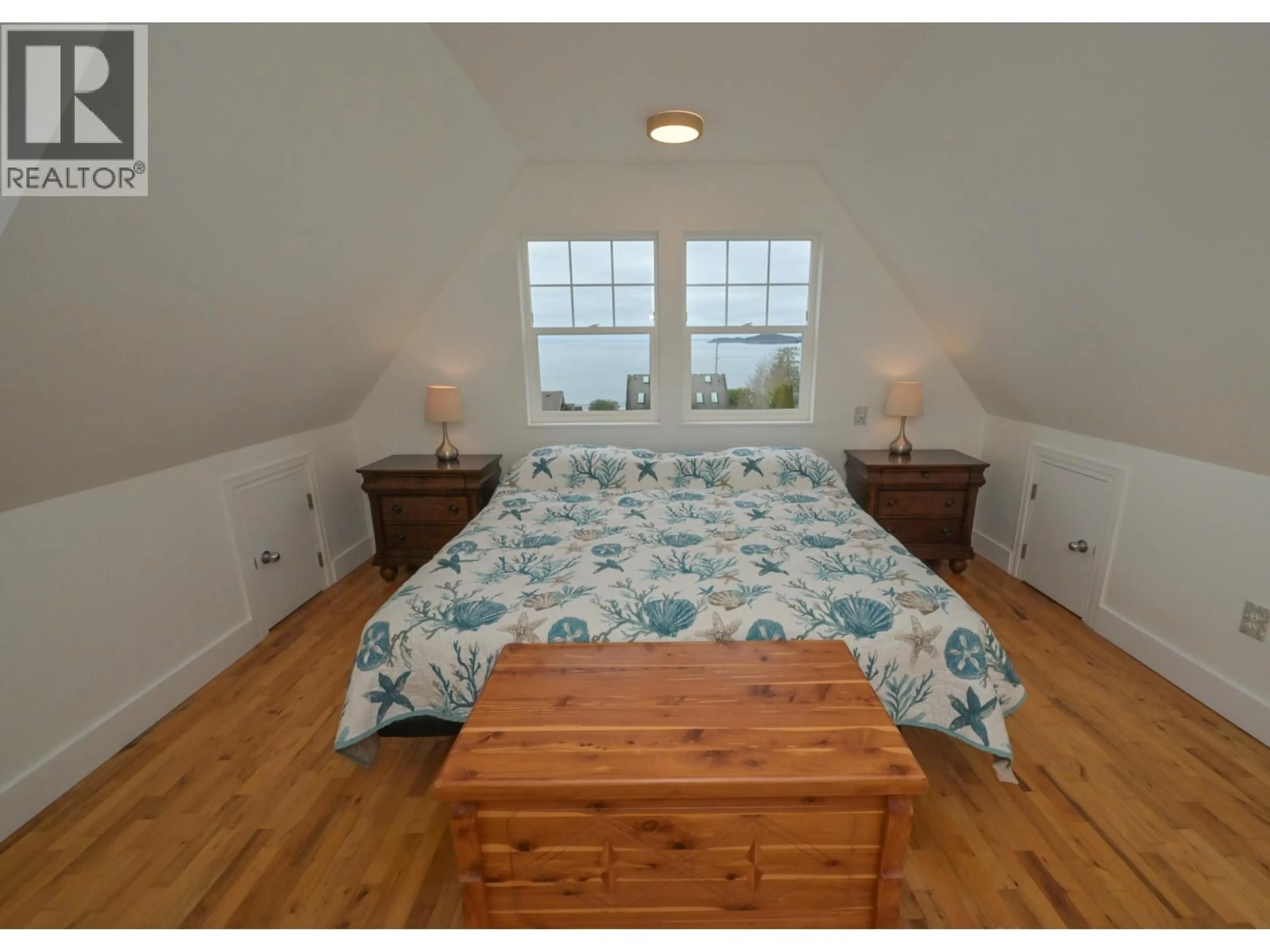 Bedroom with bed, wood/laminate floor for 5160 BAY ROAD, Sechelt British Columbia V7Z0G3