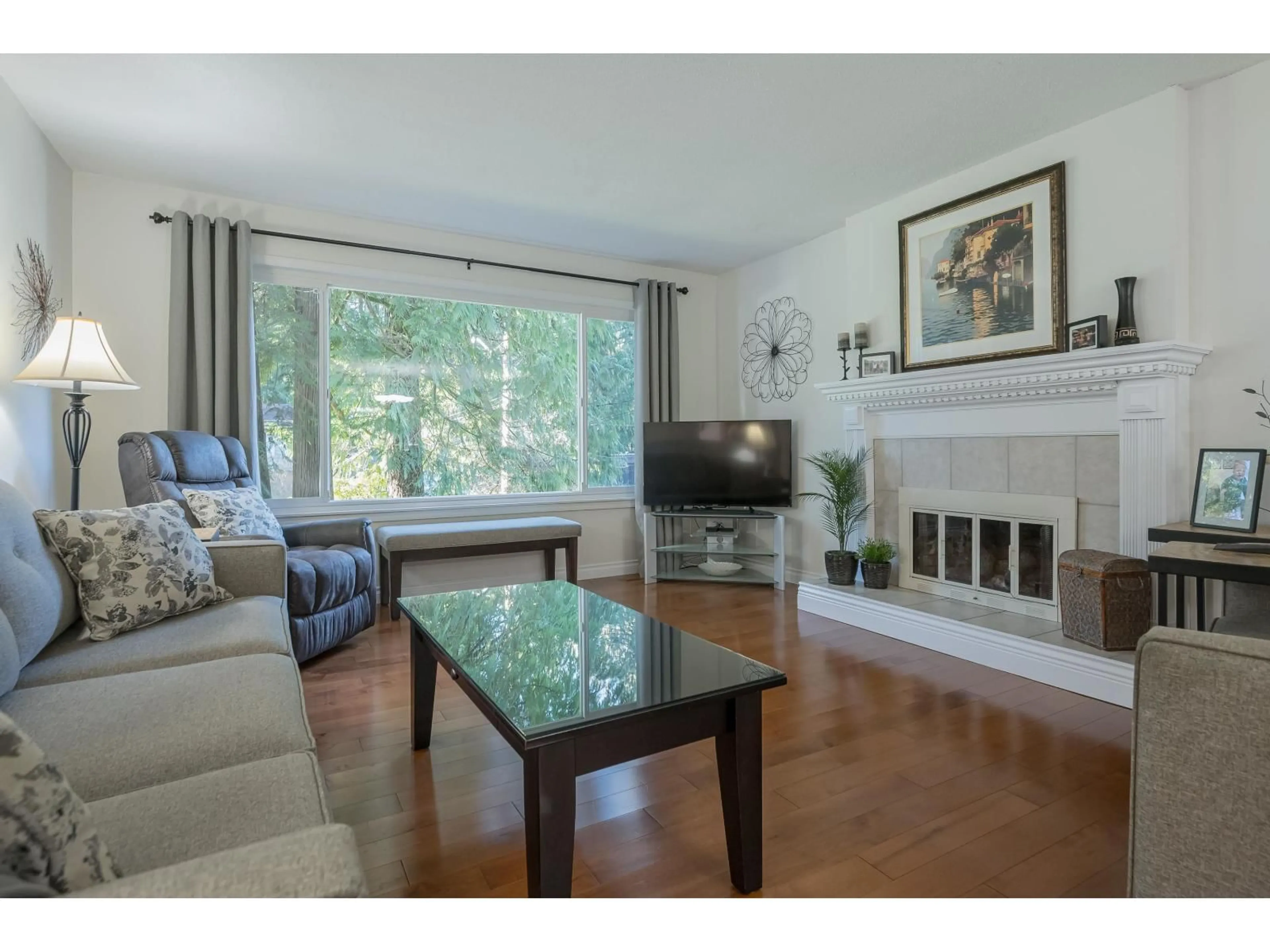 Living room with furniture, wood/laminate floor for 3828 201 STREET, Langley British Columbia V3A1P2