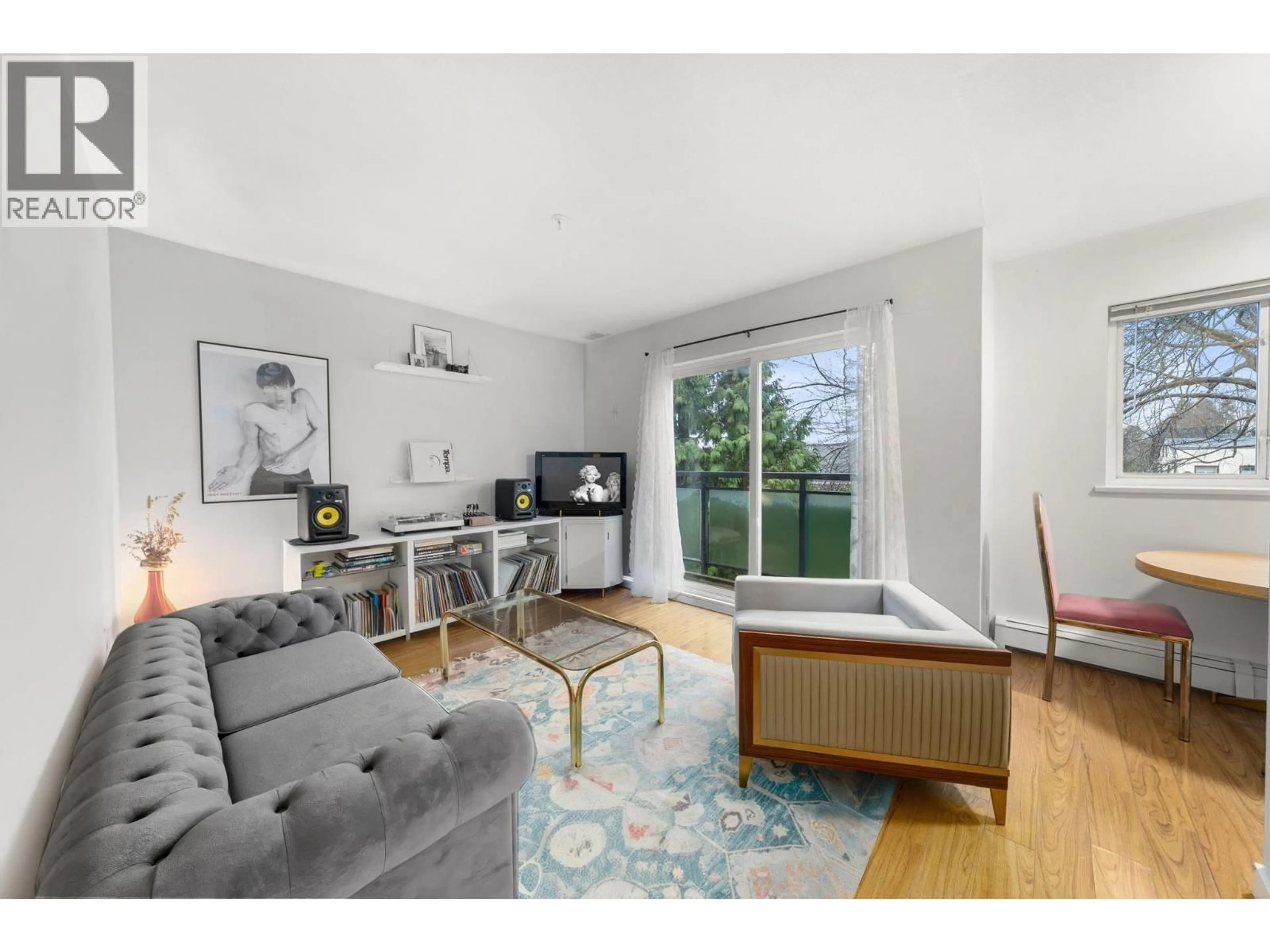 Living room with furniture, wood/laminate floor for 401 - 33 TEMPLETON DRIVE, Vancouver British Columbia V5L3C9