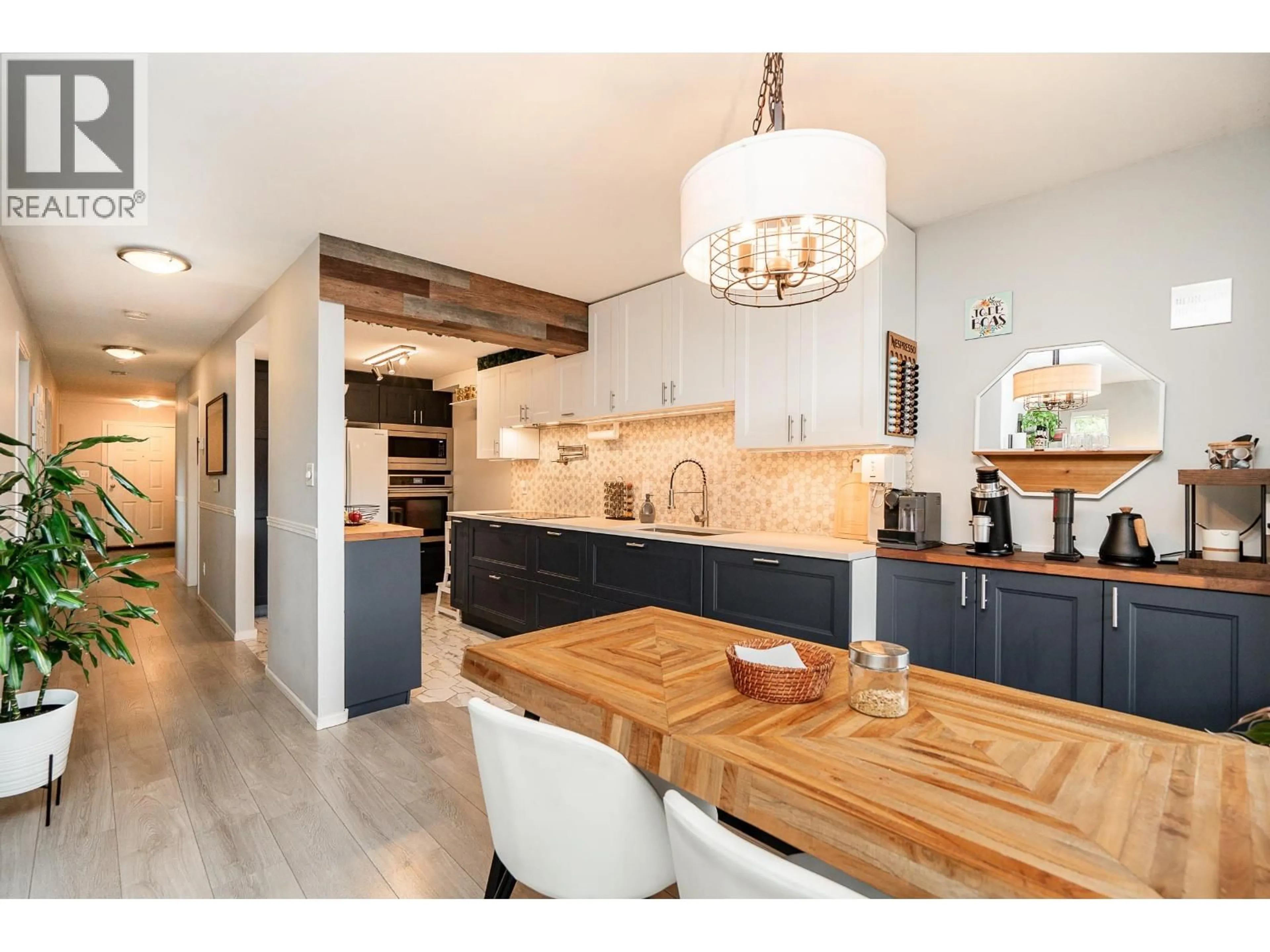 Open concept kitchen, wood/laminate floor for 301 - 7465 SANDBORNE AVENUE, Burnaby British Columbia V3N4W7