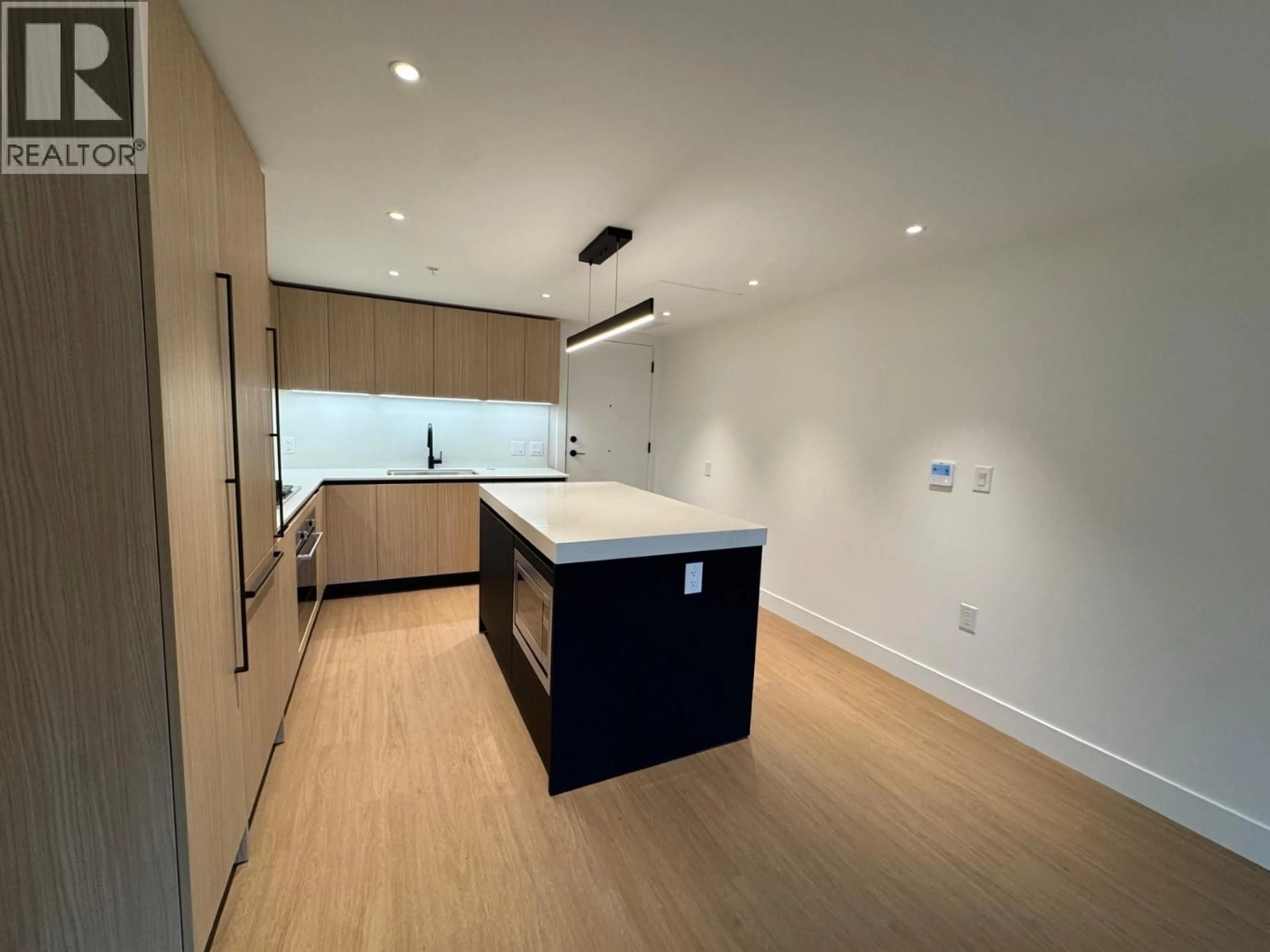 Open concept kitchen, wood/laminate floor for 113 - 2235 BROADWAY, Vancouver British Columbia V5N0J5