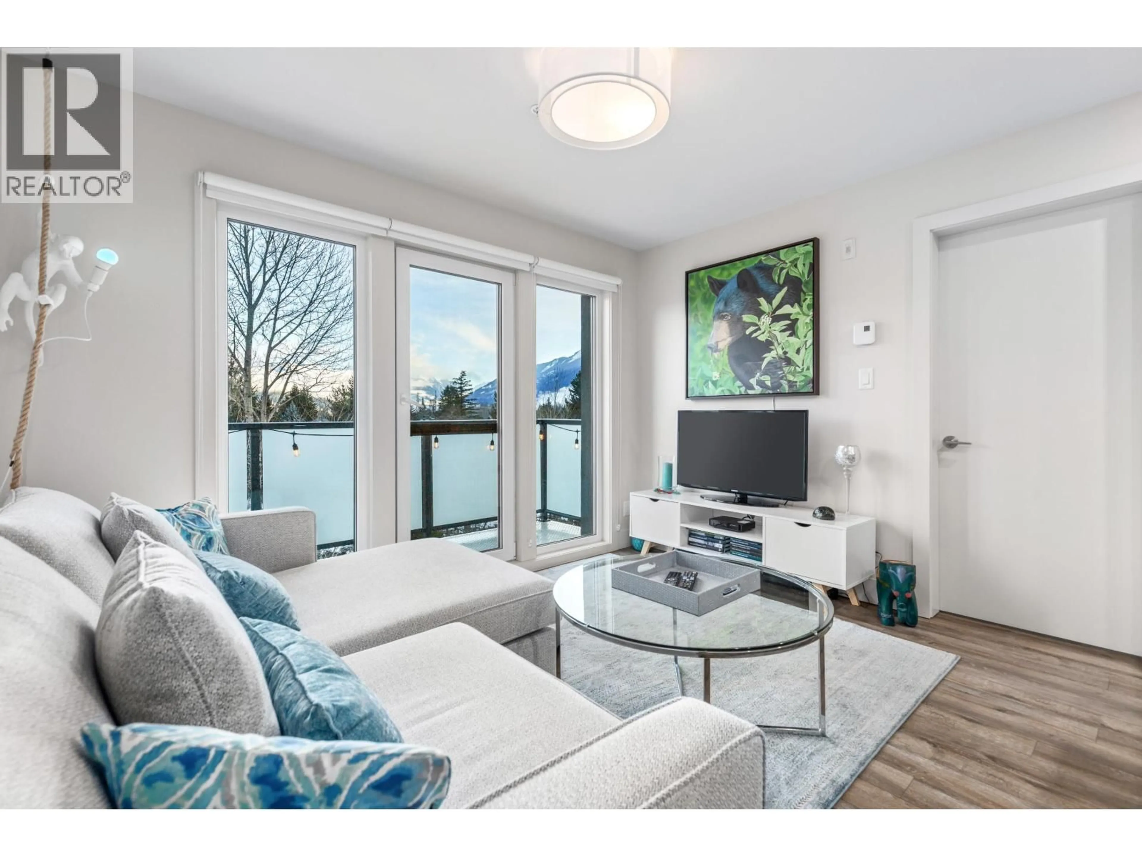 Living room with furniture, wood/laminate floor for 313 - 7350 CRABAPPLE COURT, Pemberton British Columbia V0N2L1