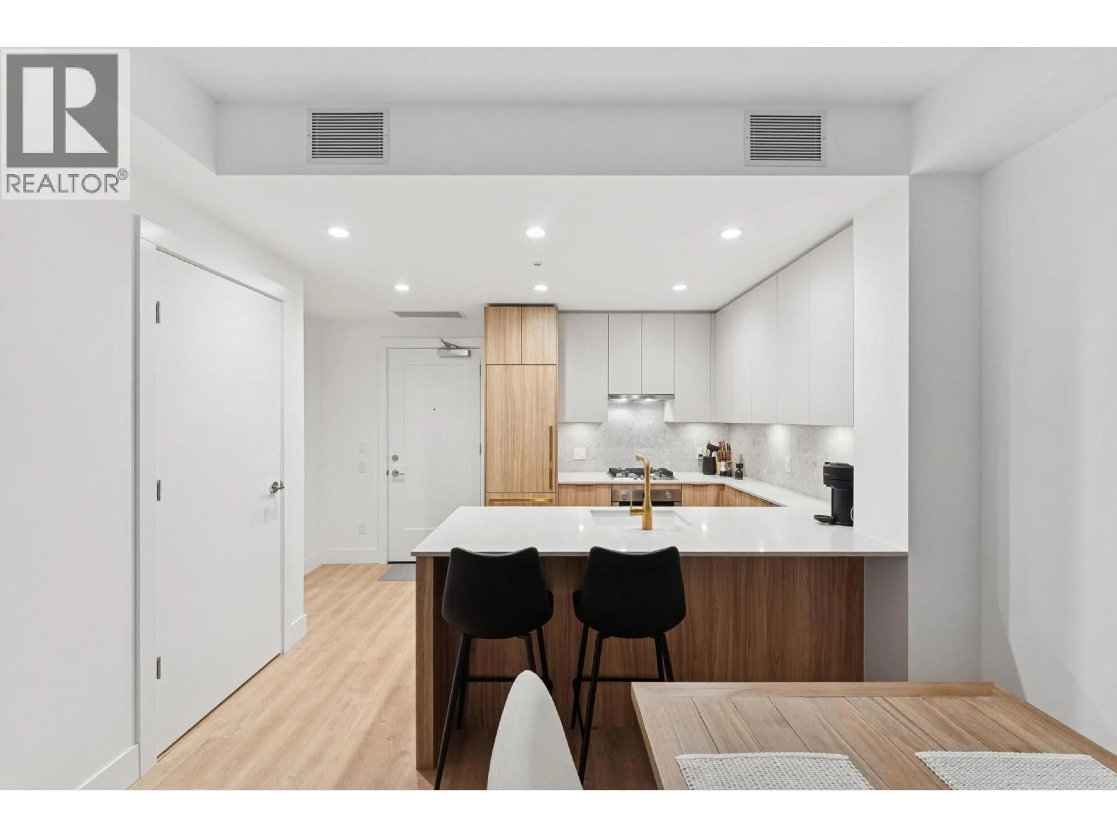 Open concept kitchen, wood/laminate floor for 208 - 2375 EMERY COURT, North Vancouver British Columbia V7J0E8