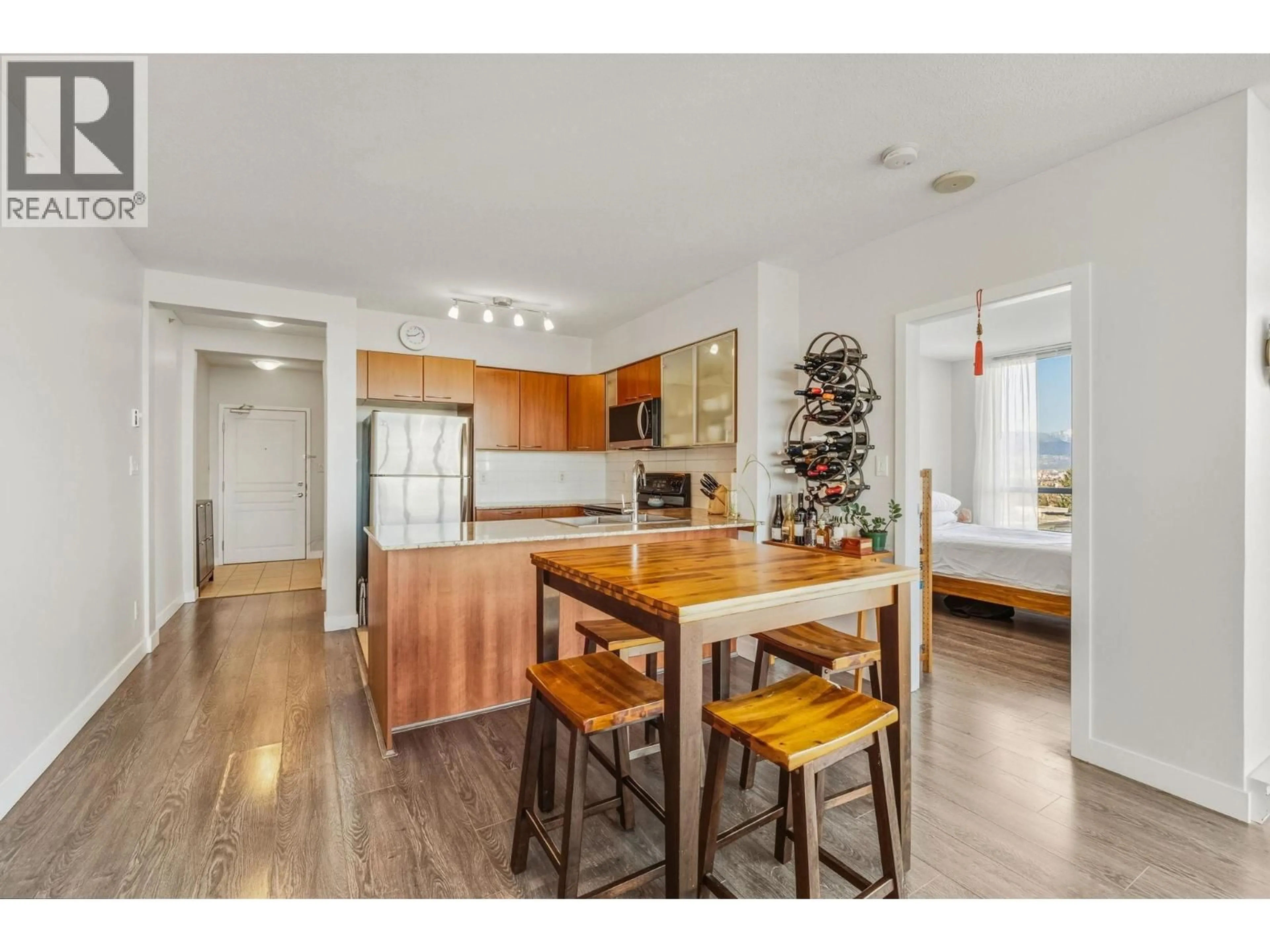 Open concept kitchen, wood/laminate floor for 751 - 1483 KING EDWARD AVENUE, Vancouver British Columbia V5N5Z3