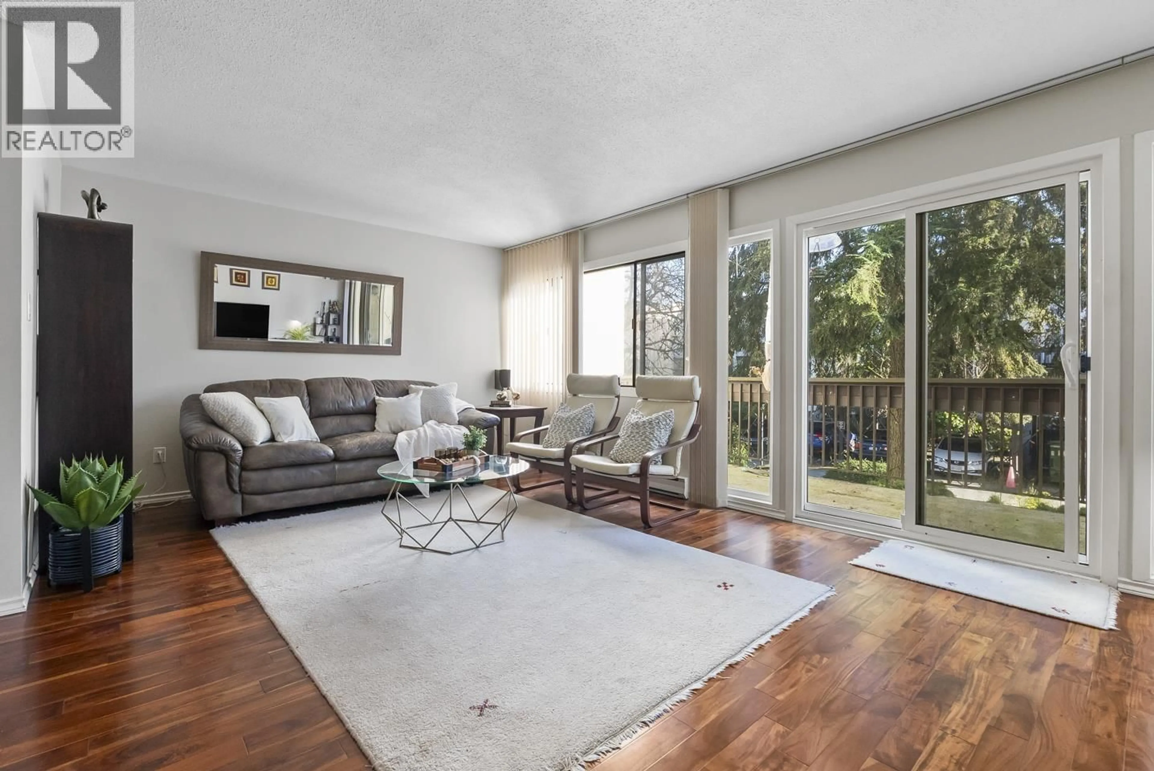 Living room with furniture, wood/laminate floor for 5 - 7307 MONTECITO DRIVE, Burnaby British Columbia V5A1R2