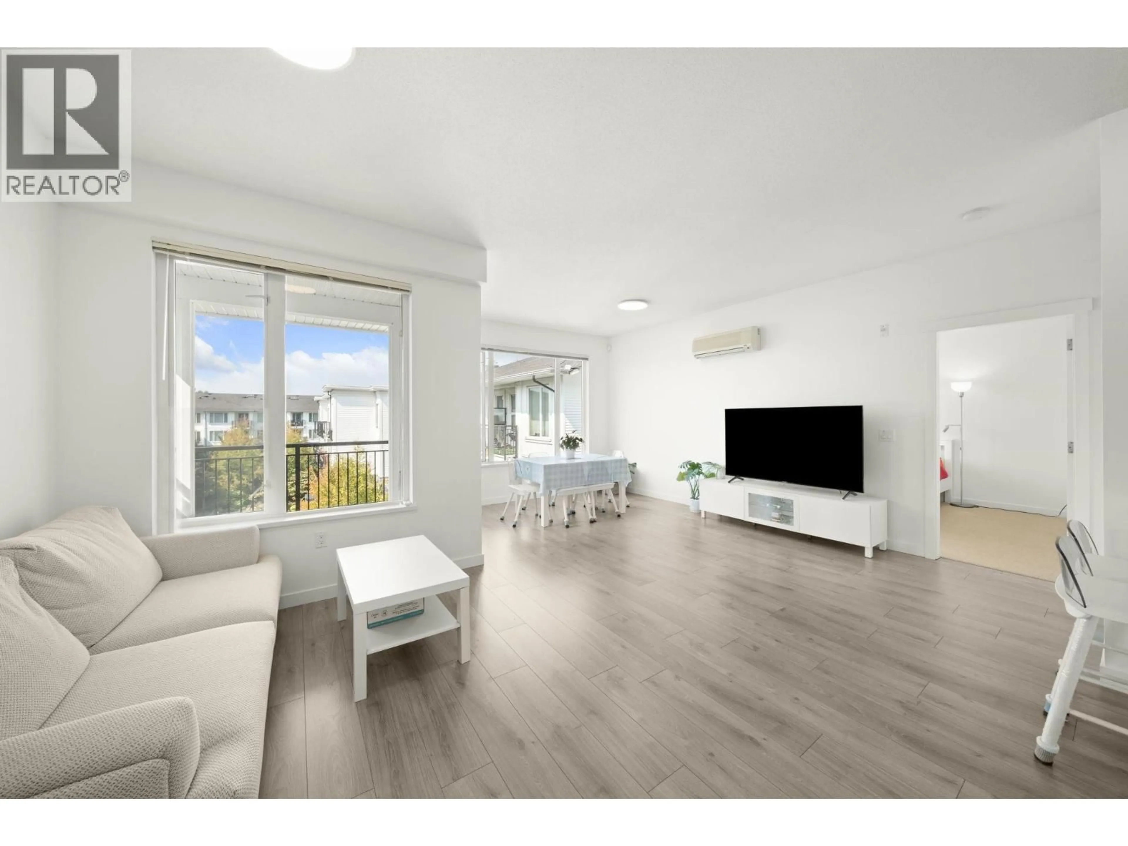 Living room with furniture, wood/laminate floor for 438 - 9388 MCKIM WAY, Richmond British Columbia V6X0J7