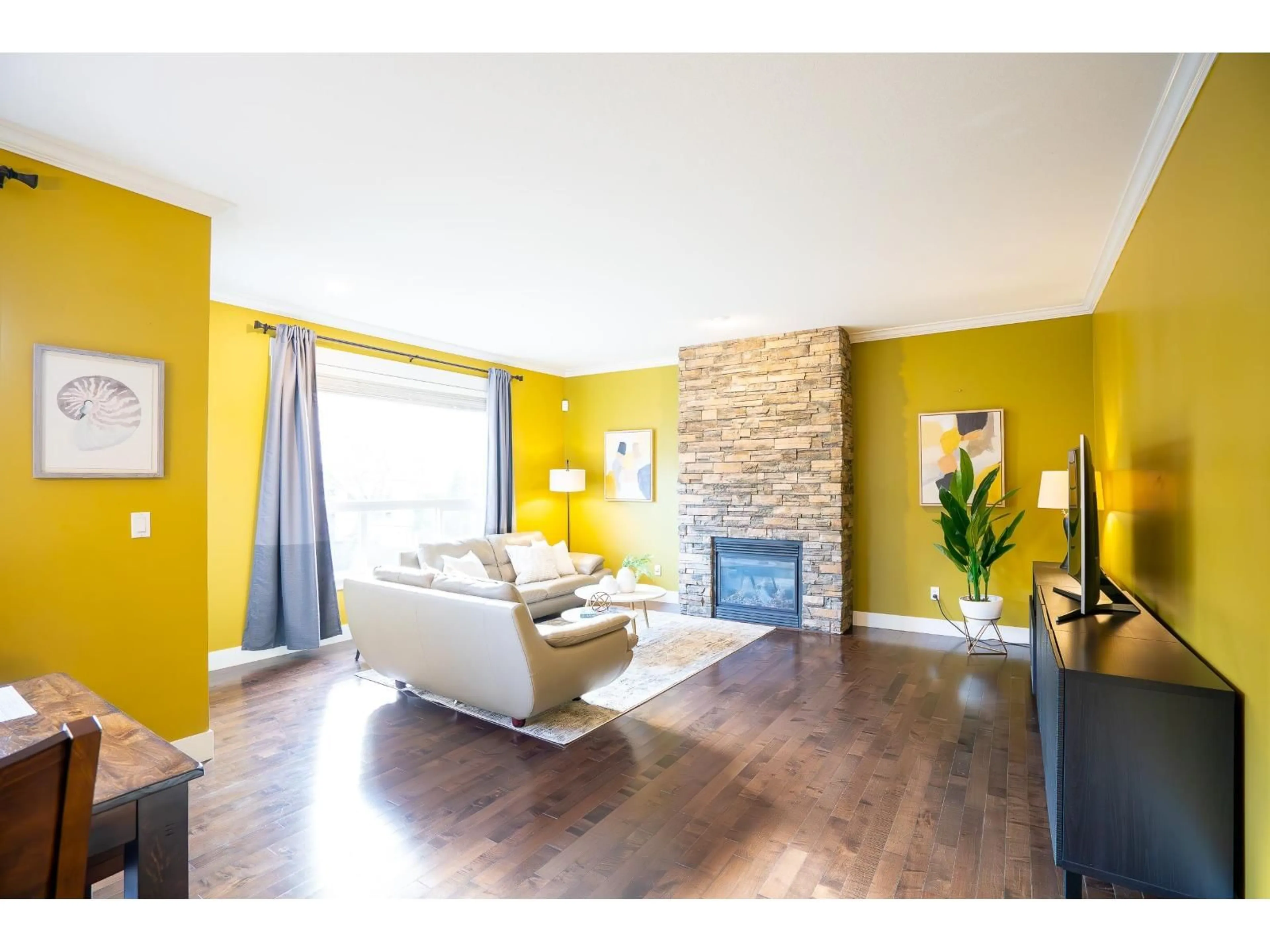 Living room with furniture, wood/laminate floor for 17916 71 AVENUE, Surrey British Columbia V3S7C7