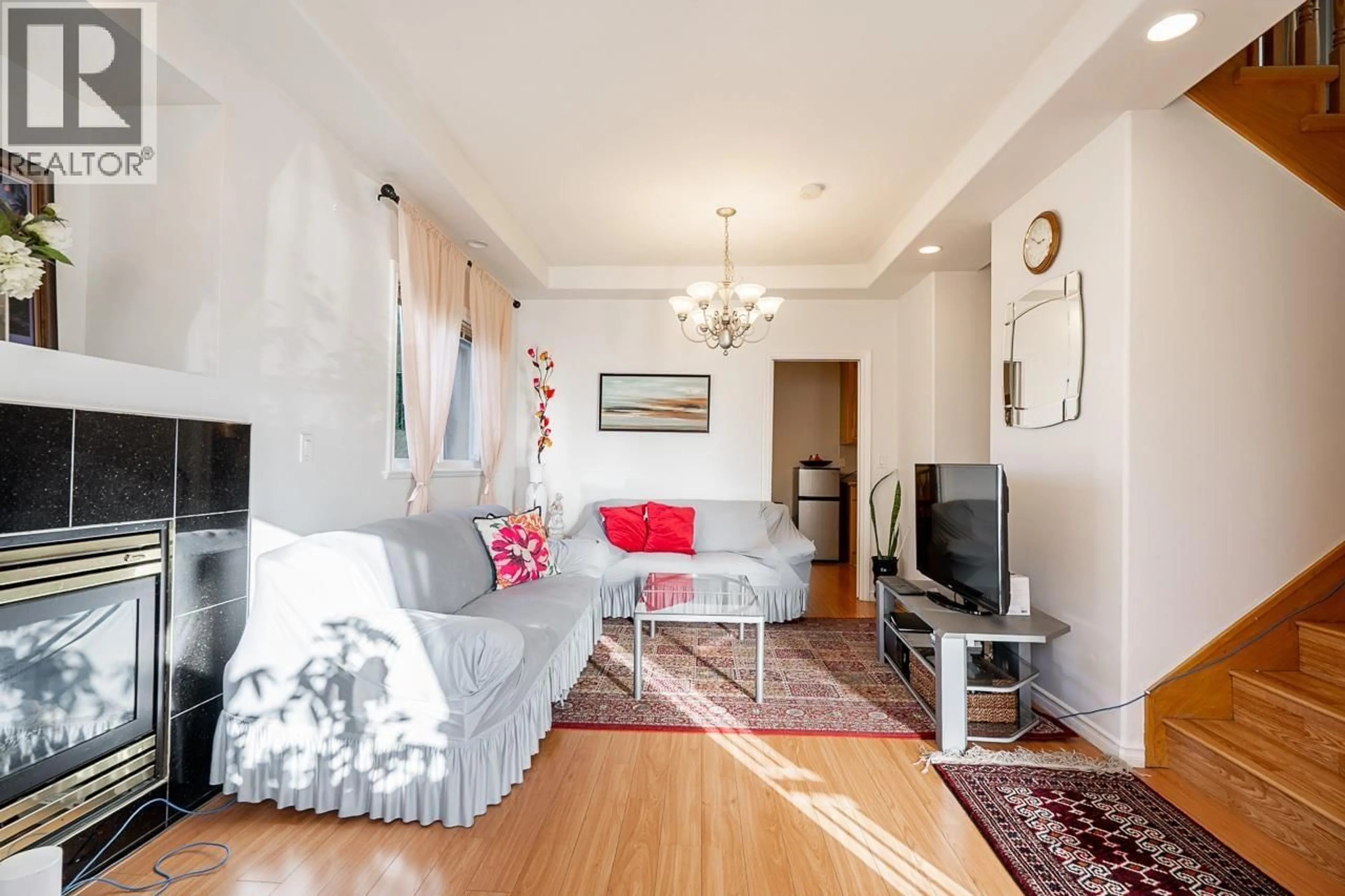 Living room with furniture, wood/laminate floor for 6980 HUMPHRIES AVENUE, Burnaby British Columbia V5E4N4