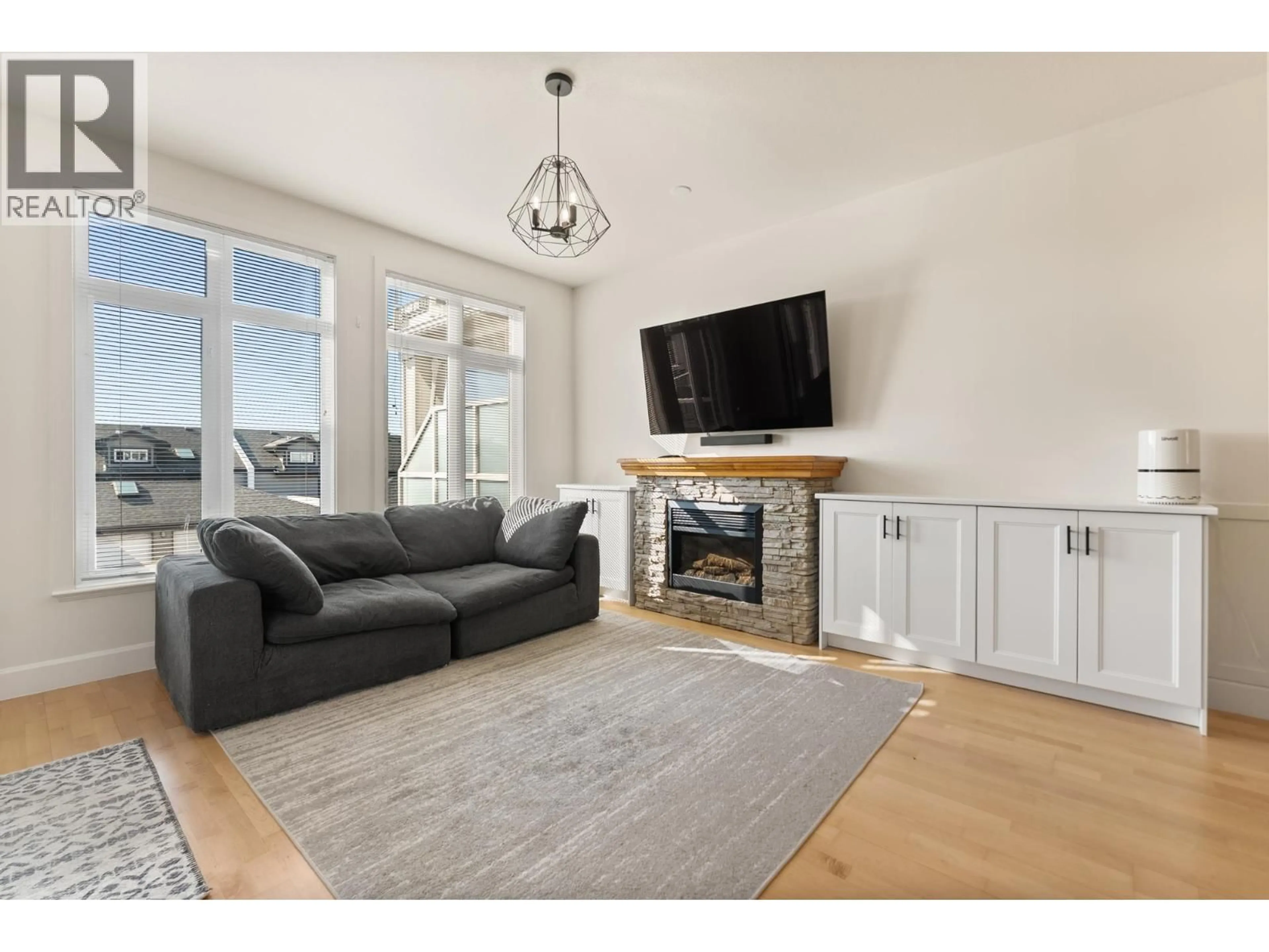 Living room with furniture, wood/laminate floor for 311 - 4280 MONCTON STREET, Richmond British Columbia V7E6T4