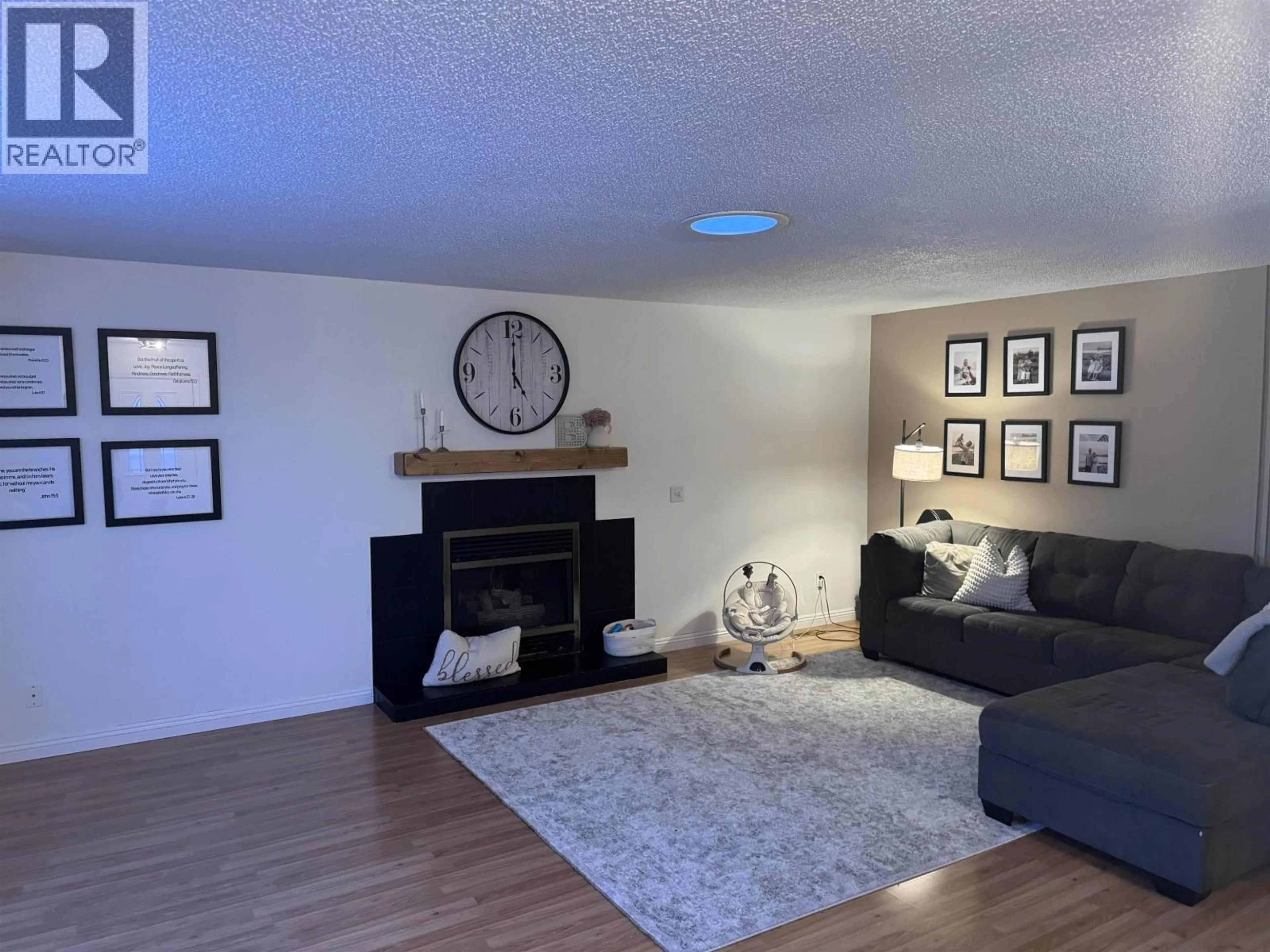 Living room with furniture, wood/laminate floor for 9219 103 AVENUE, Fort St. John British Columbia V1J2G6