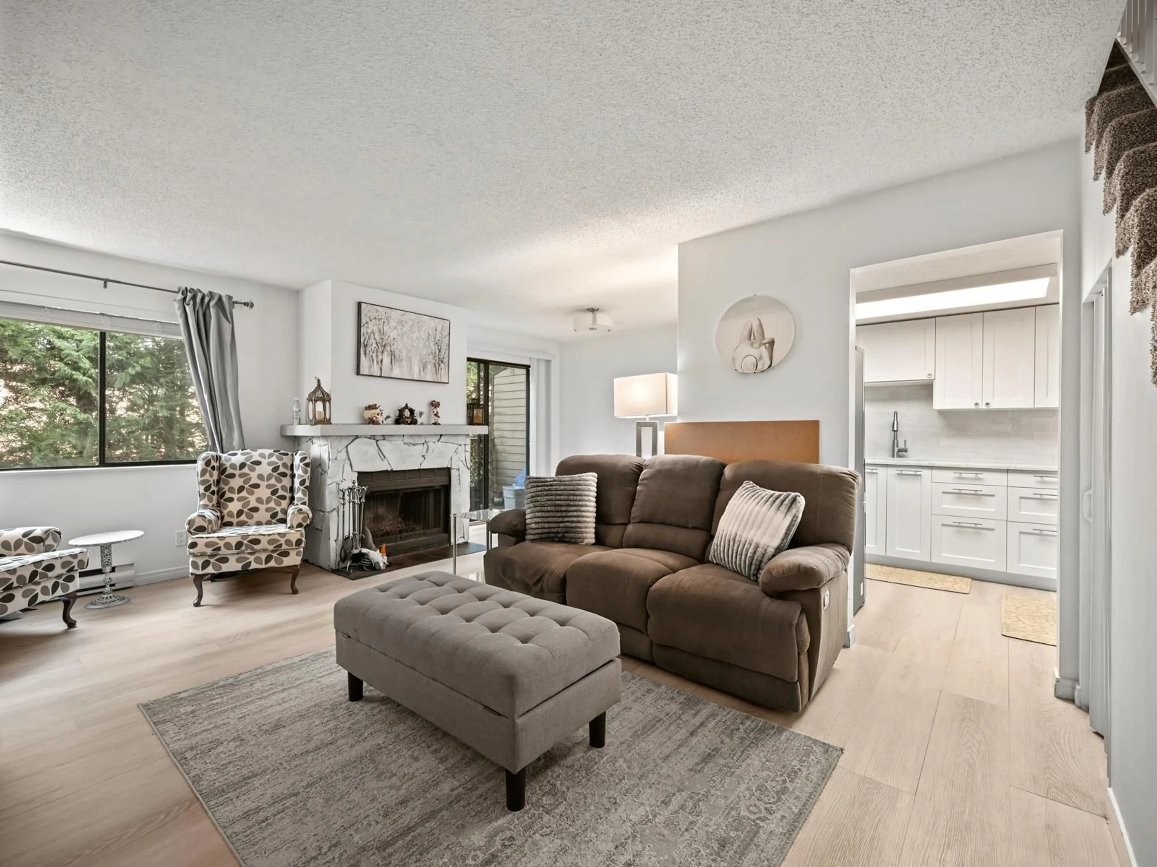 Living room with furniture, wood/laminate floor for 202 - 7095 133B STREET, Surrey British Columbia V3W8A3
