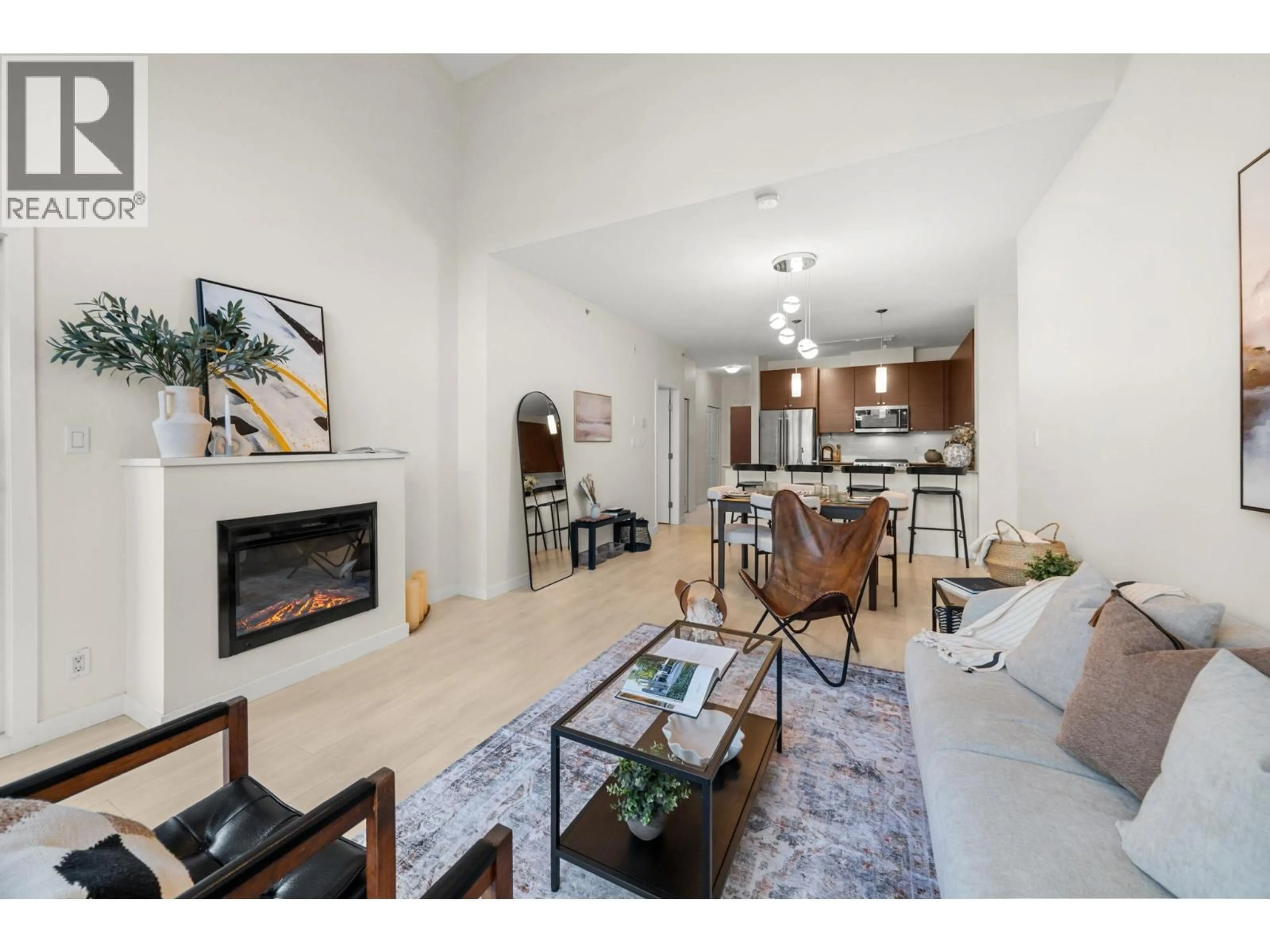 Living room with furniture, wood/laminate floor for 407 - 201 MORRISSEY ROAD, Port Moody British Columbia V3H0E5