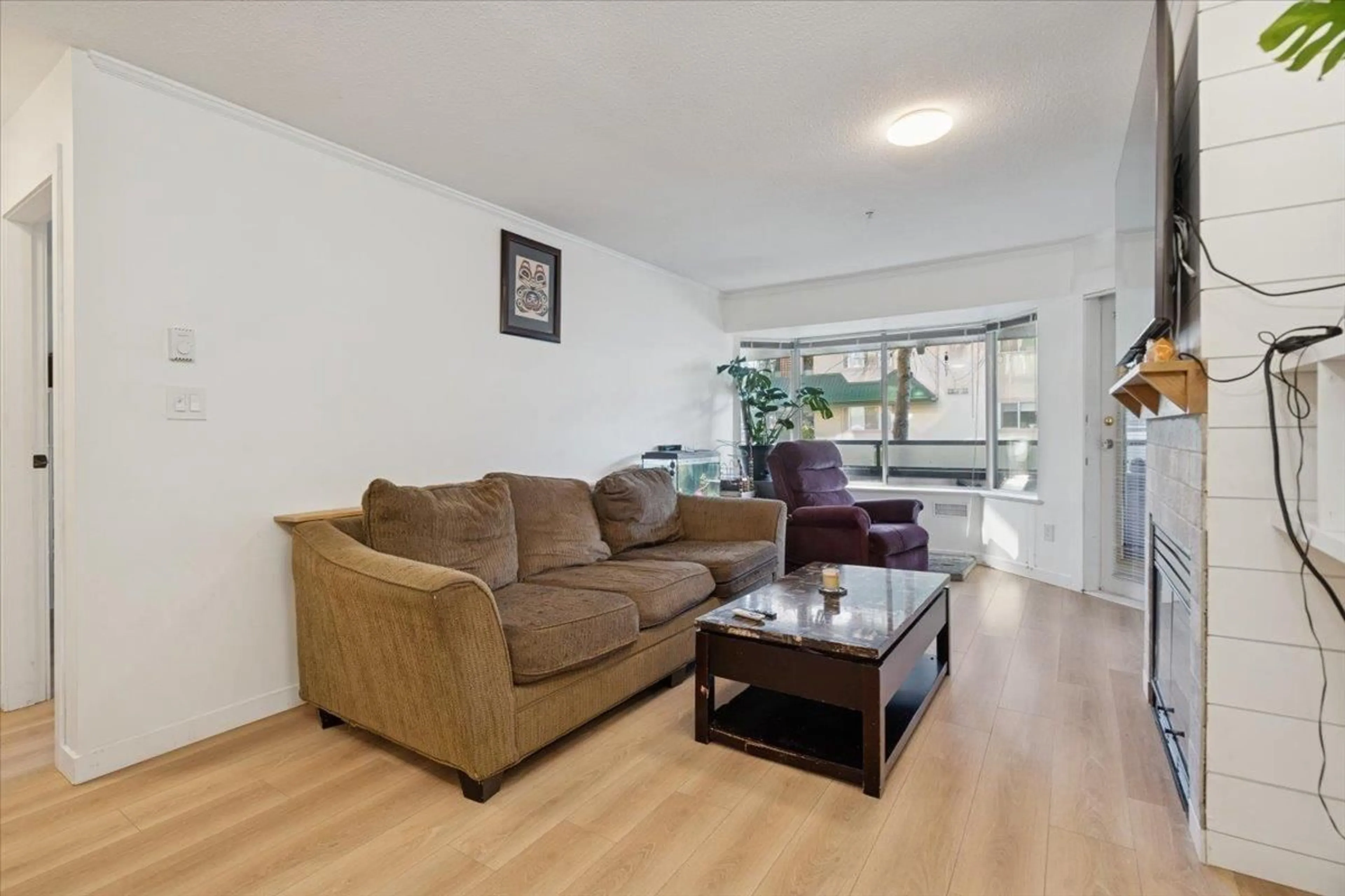 Living room with furniture, wood/laminate floor for 105 - 2962 TRETHEWEY STREET, Abbotsford British Columbia V2T4M3