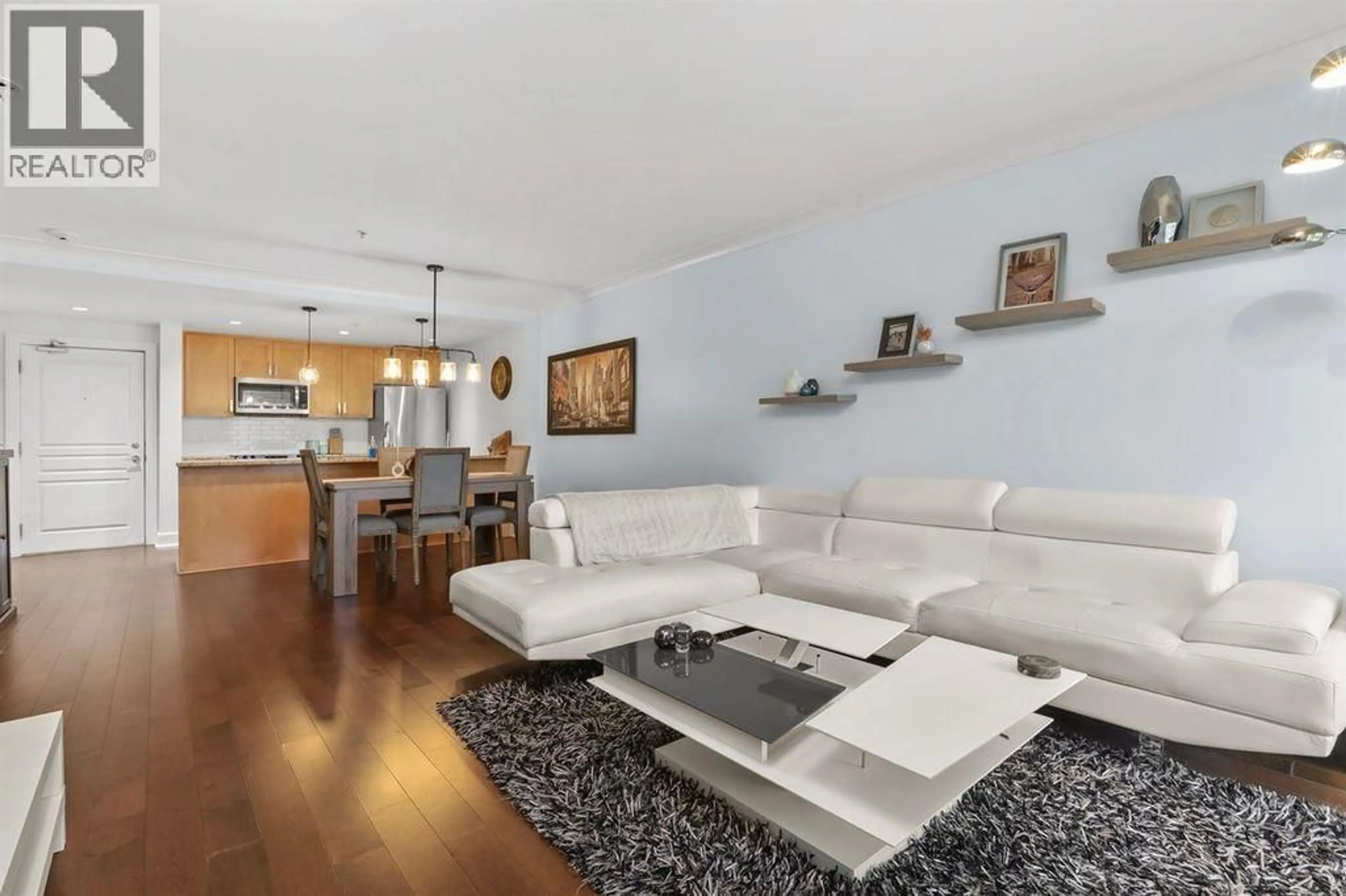 Living room with furniture, wood/laminate floor for 205 - 5599 14B AVENUE, Tsawwassen British Columbia V4M0A3