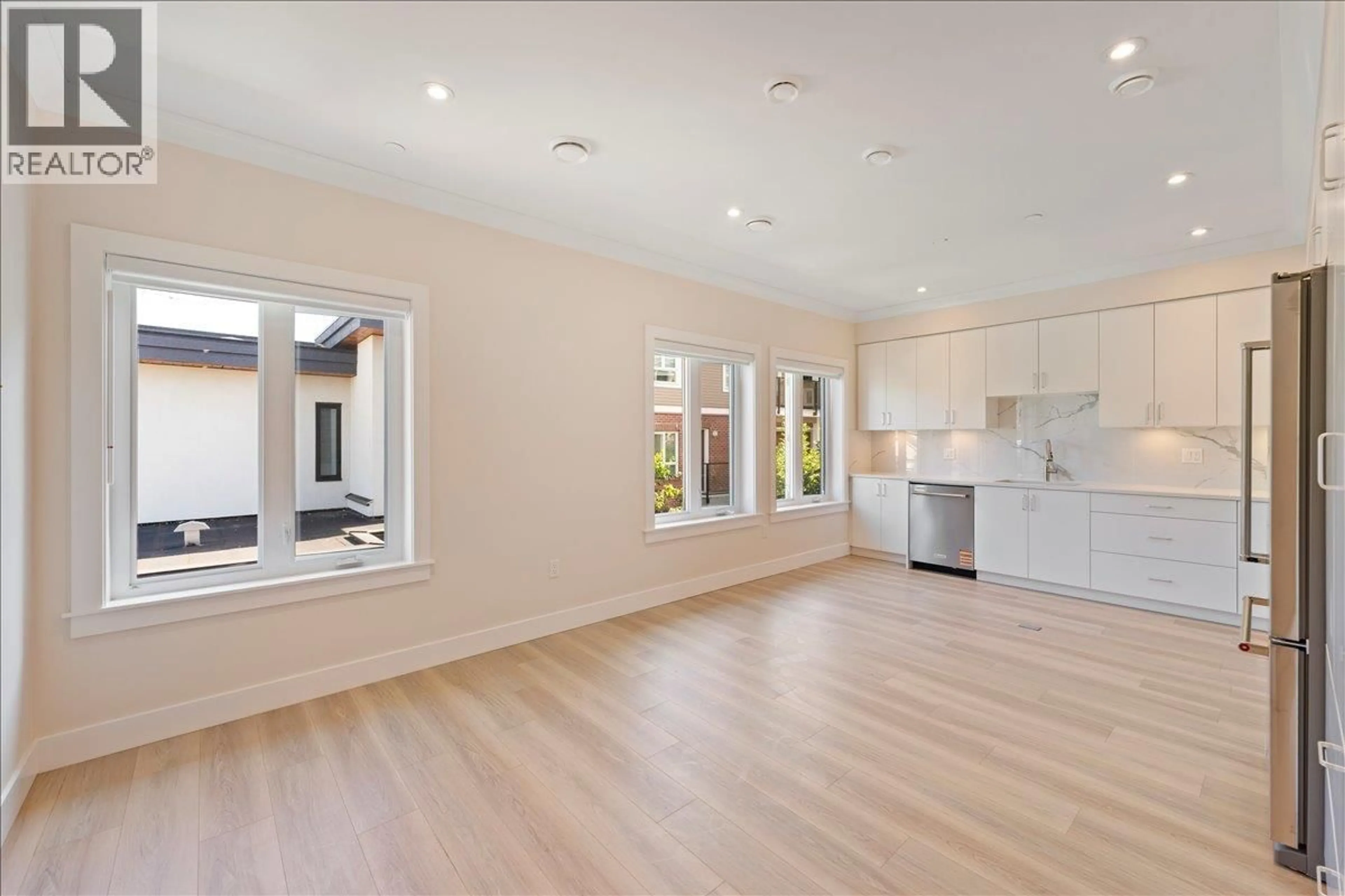 Open concept kitchen, wood/laminate floor for 4854 SLOCAN STREET, Vancouver British Columbia V5R2A3