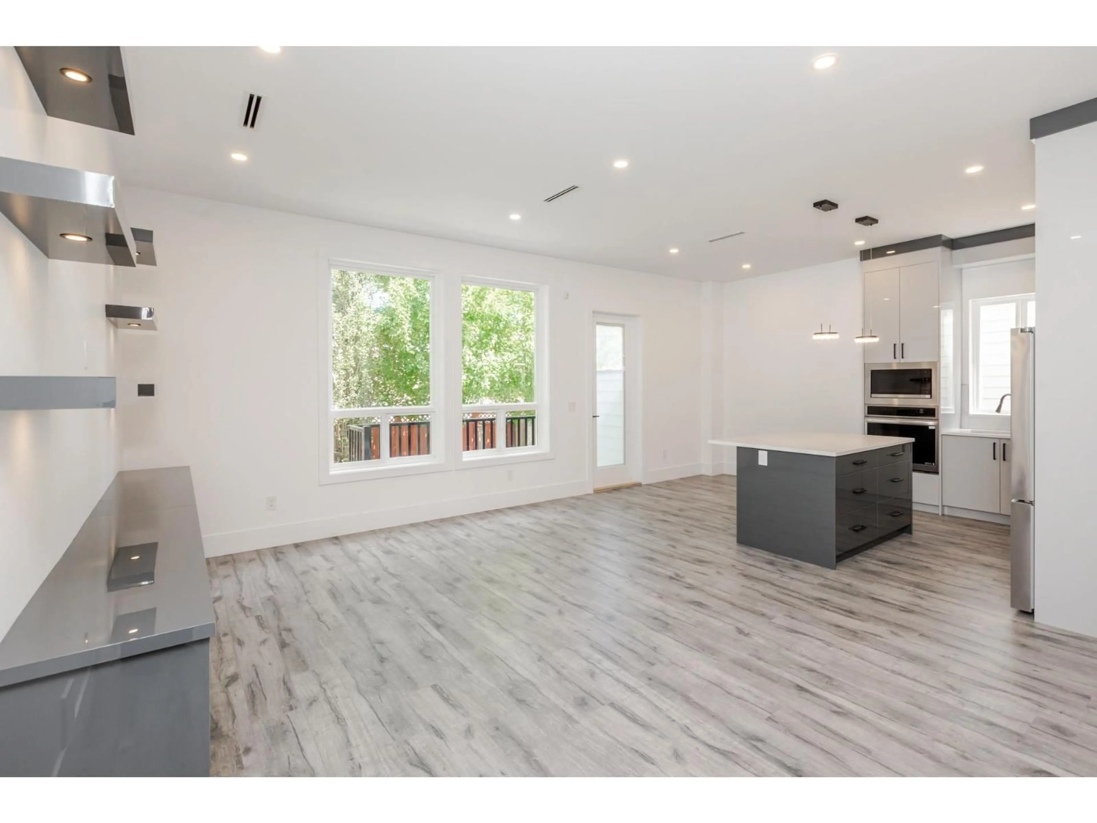 Open concept kitchen, wood/laminate floor for 11729 85A AVENUE, Delta British Columbia V4C2V7