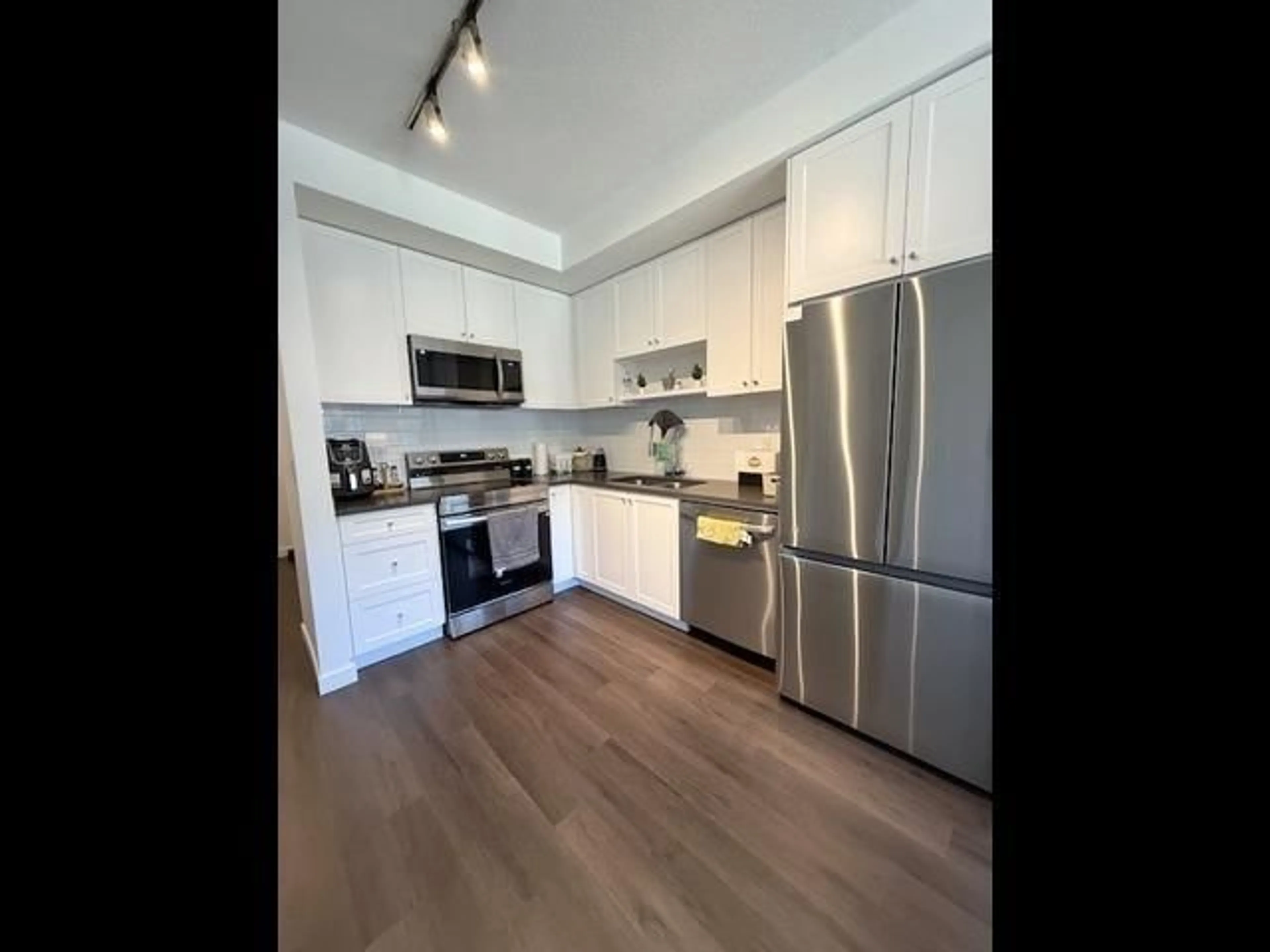 Open concept kitchen, wood/laminate floor for 420 - 8509 158 STREET, Surrey British Columbia V4N5A4