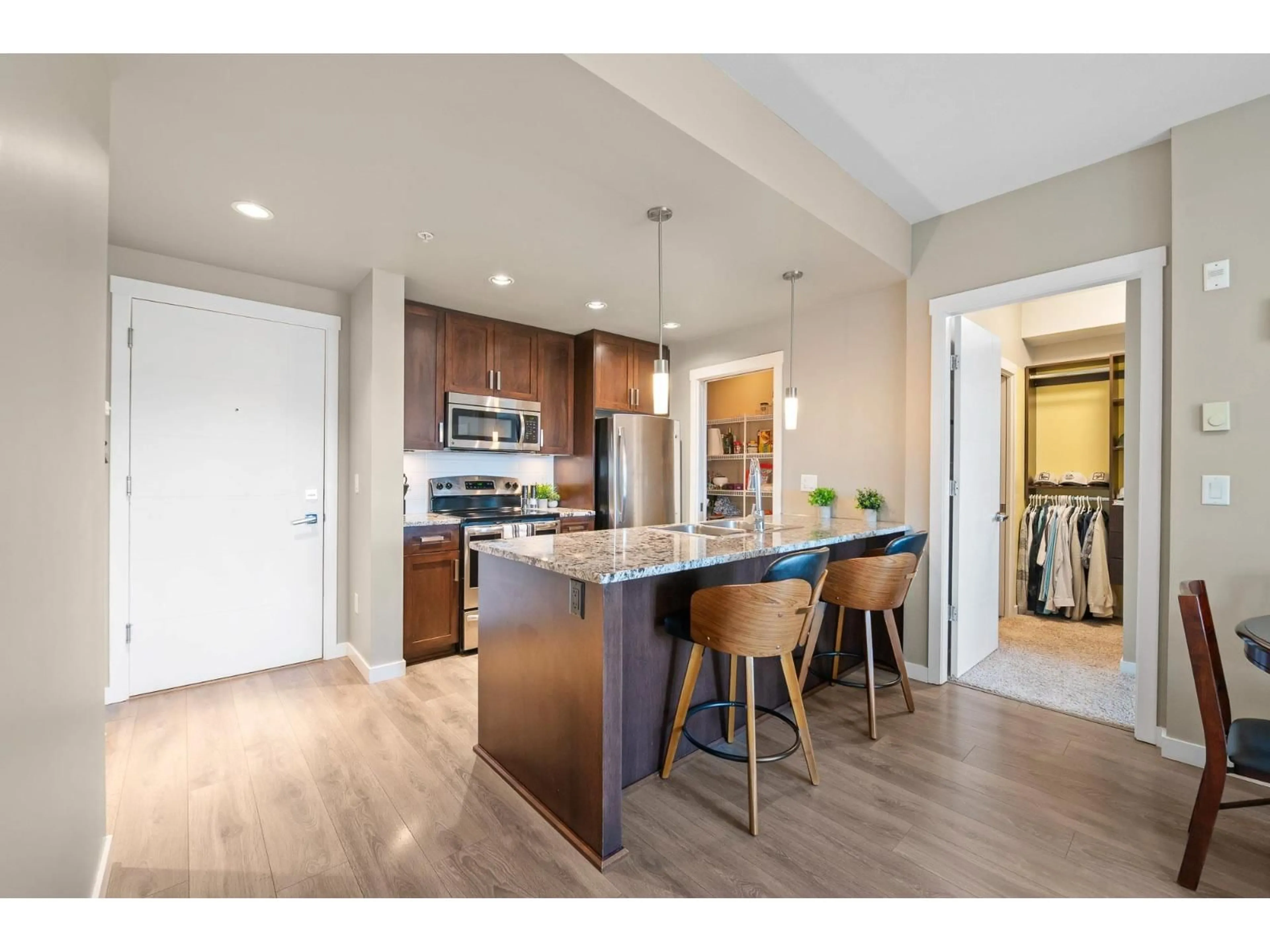 Open concept kitchen, wood/laminate floor for 209 - 2238 WHATCOM ROAD, Abbotsford British Columbia V3G0E6