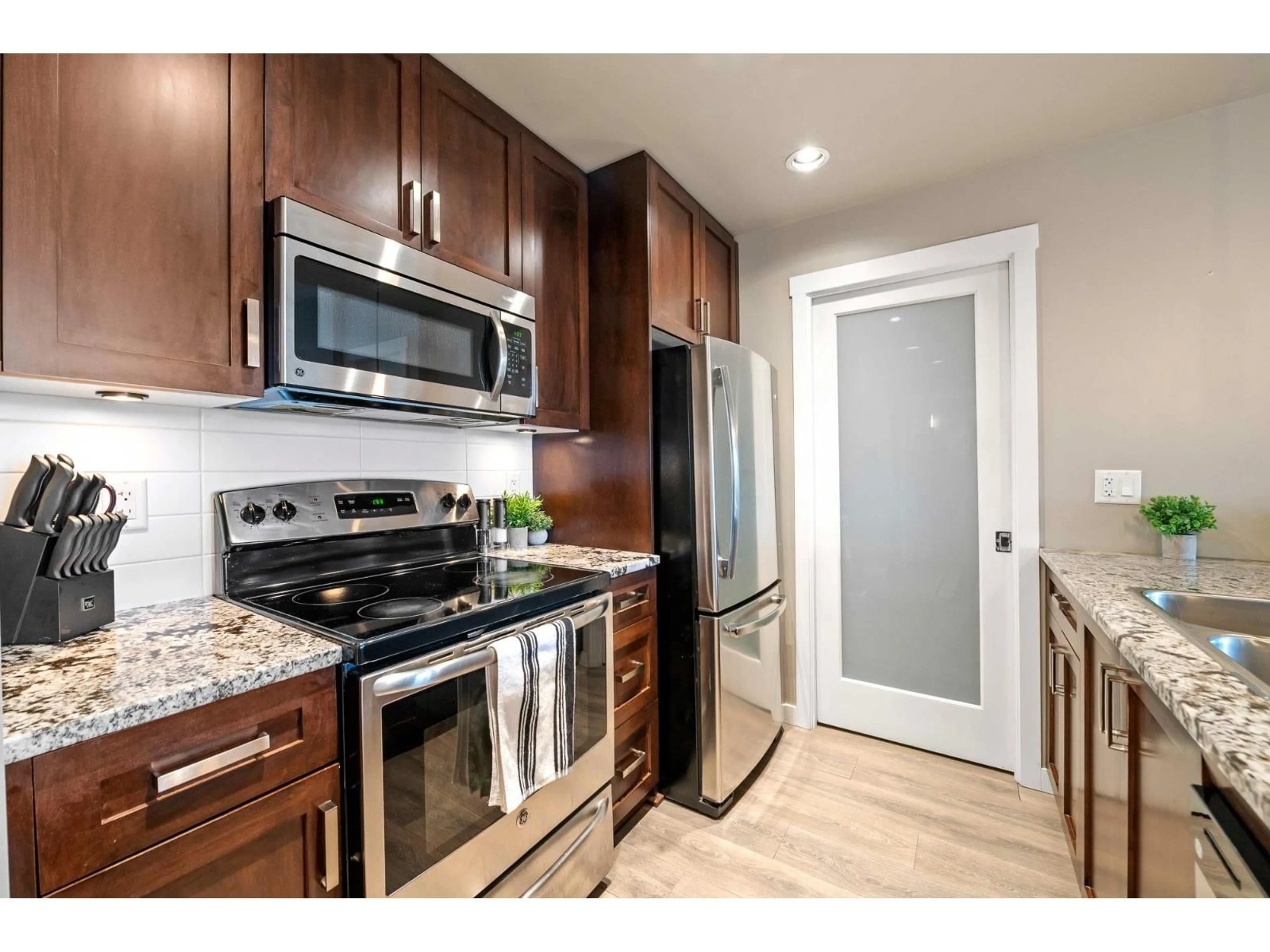 Standard kitchen, wood/laminate floor for 209 - 2238 WHATCOM ROAD, Abbotsford British Columbia V3G0E6