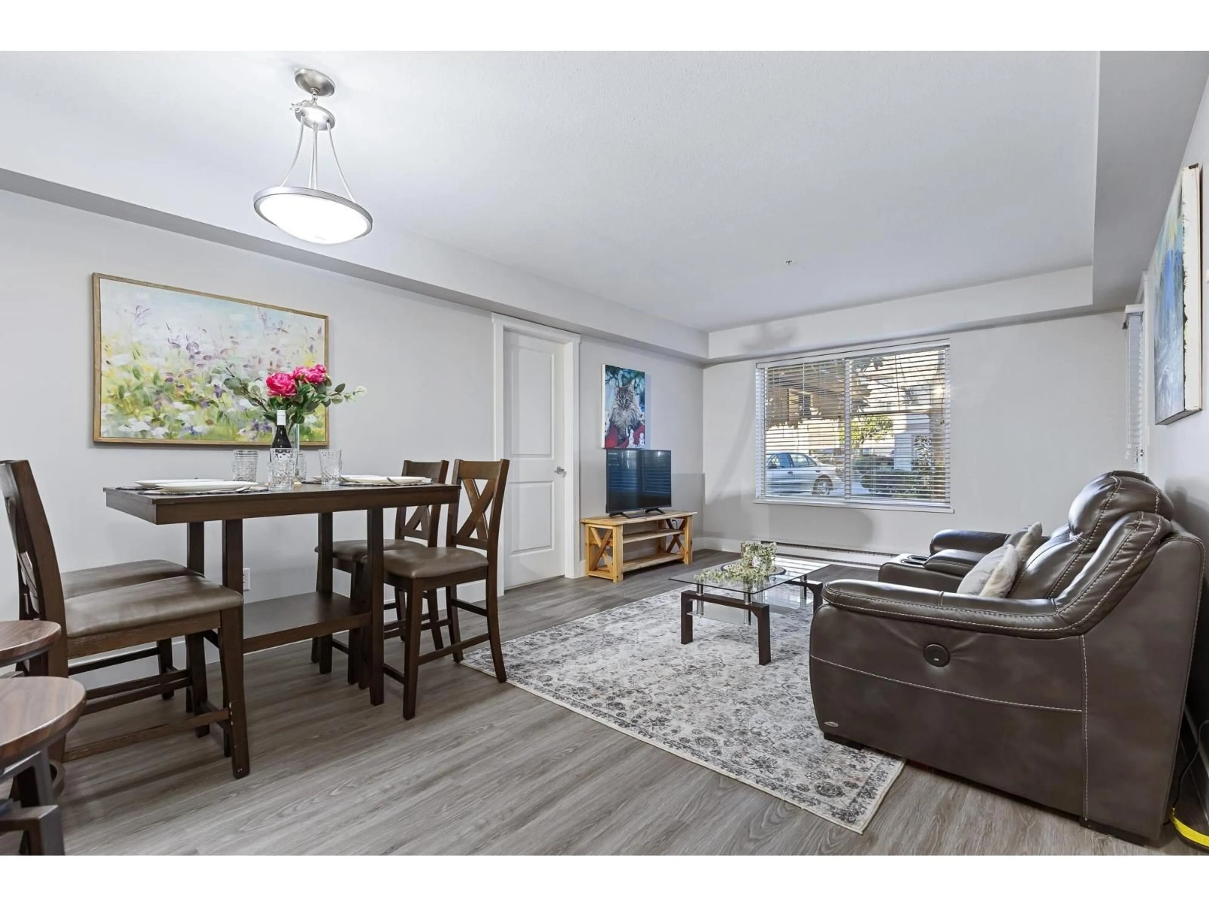 Living room with furniture, wood/laminate floor for 101 - 45555 YALE ROAD, Chilliwack British Columbia V2P0A9