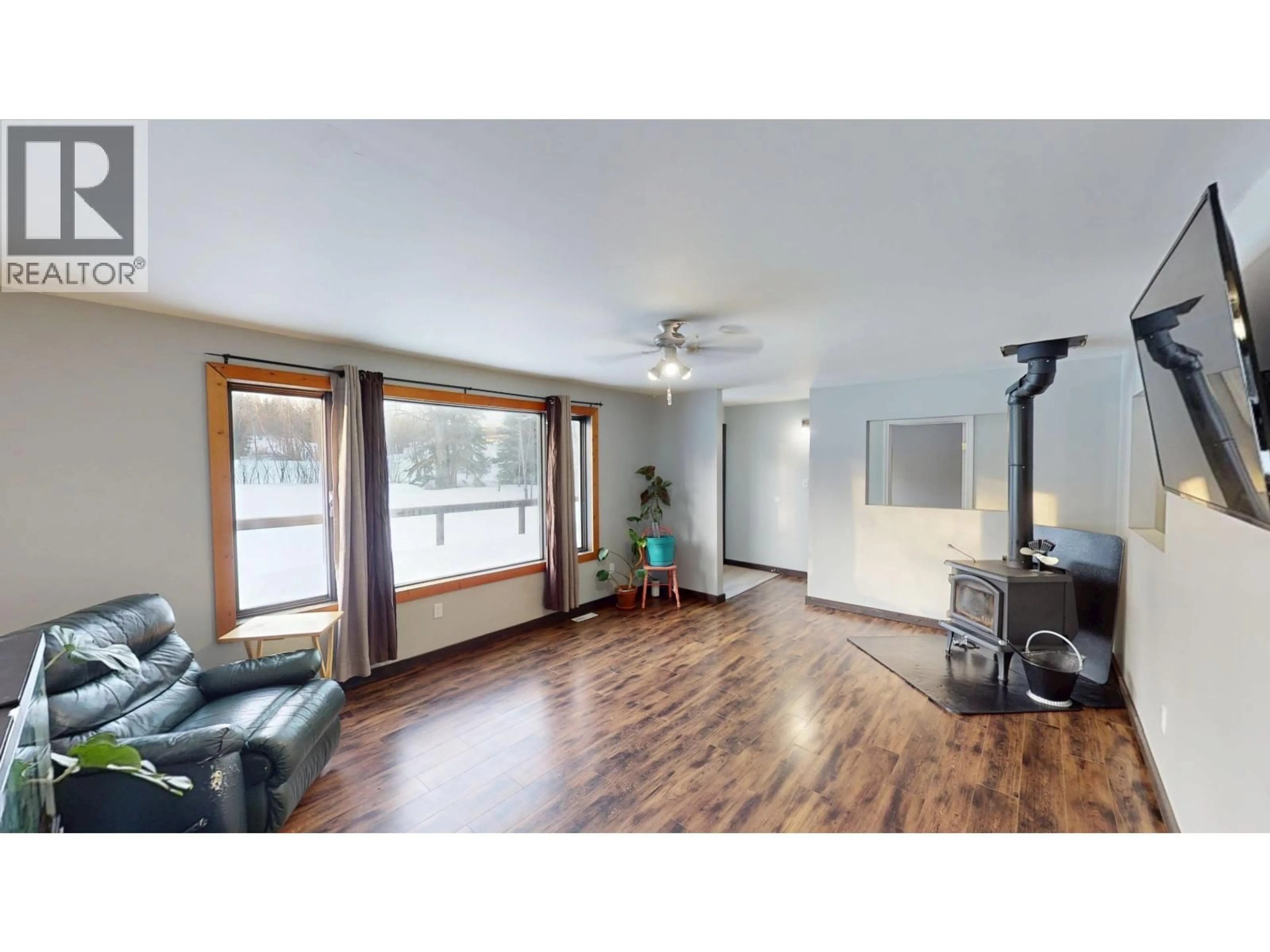 Living room with furniture, wood/laminate floor for 14651 COFFEE CREEK SUBDIV, Charlie Lake British Columbia V1J8L9