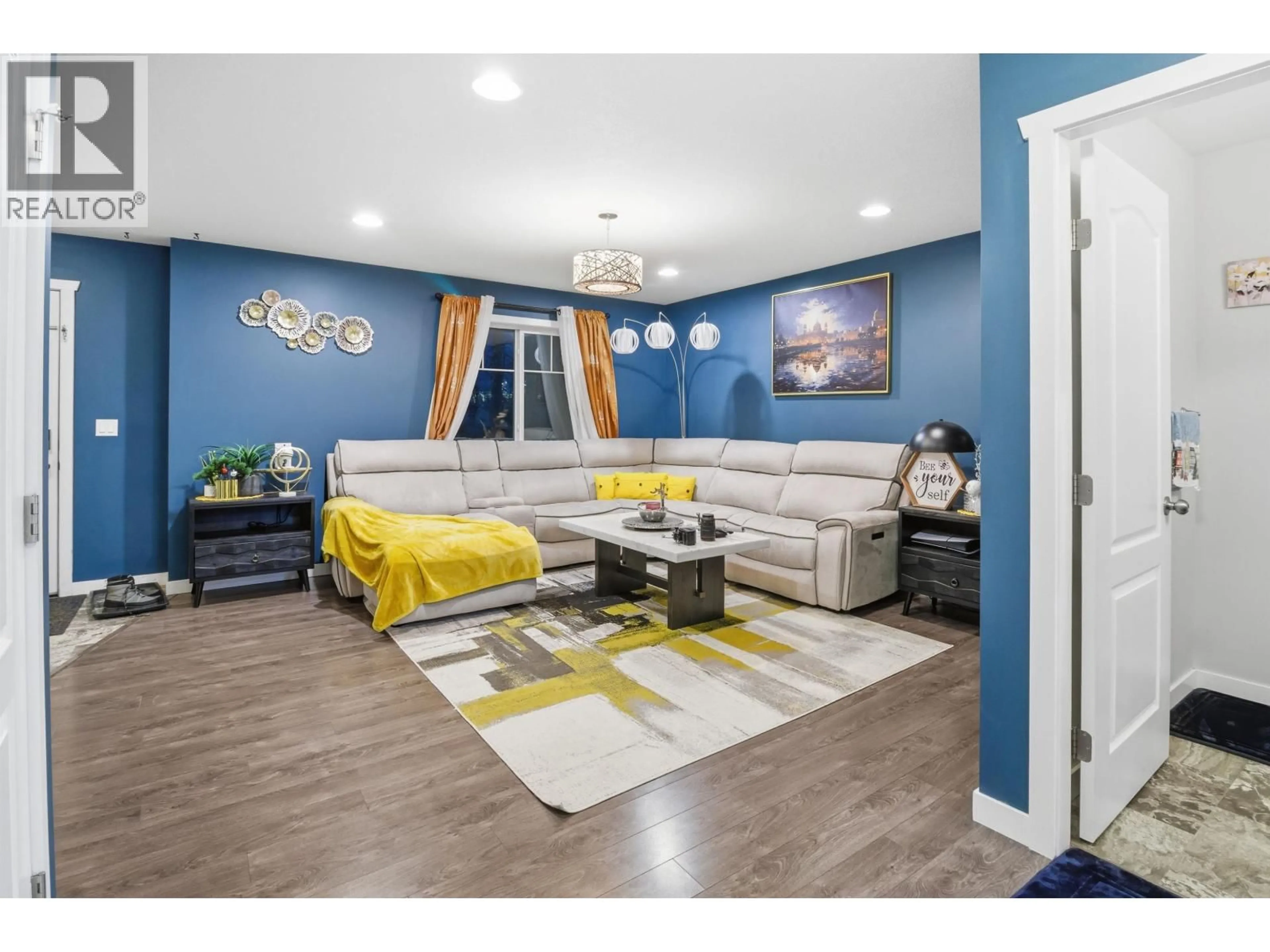 Living room with furniture, wood/laminate floor for 7617 89 AVENUE, Fort St. John British Columbia V1J5A1