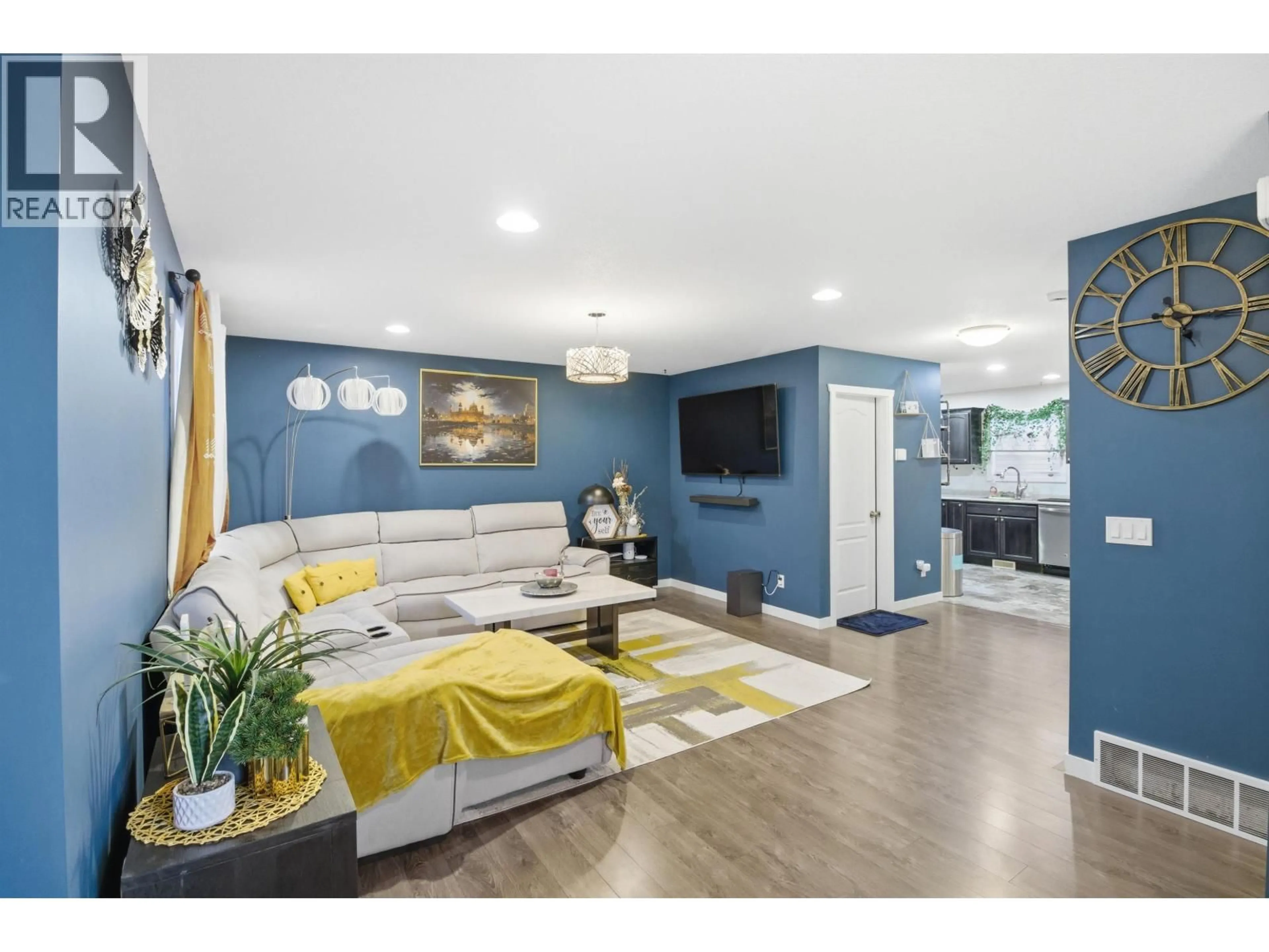 Living room with furniture, wood/laminate floor for 7617 89 AVENUE, Fort St. John British Columbia V1J5A1