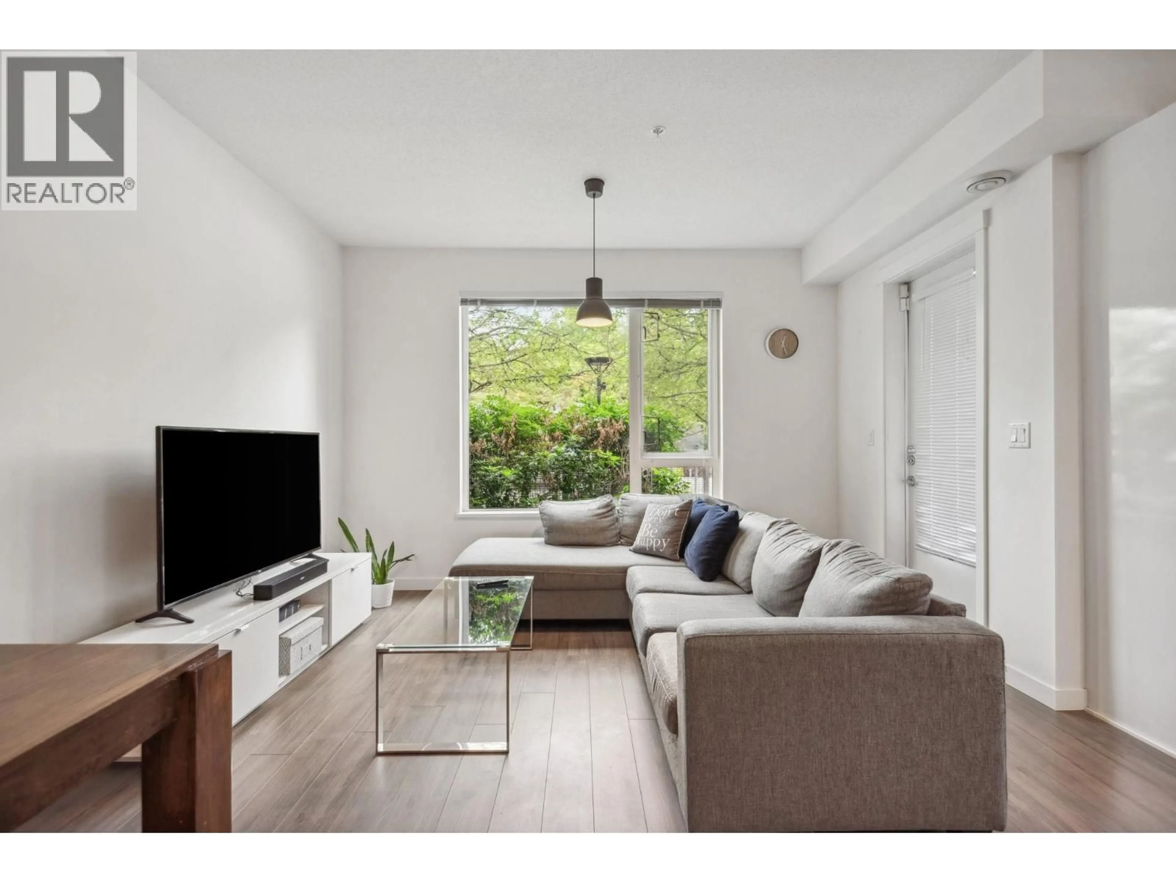 Living room with furniture, wood/laminate floor for 107 - 3138 RIVERWALK AVENUE, Vancouver British Columbia V5S0A6