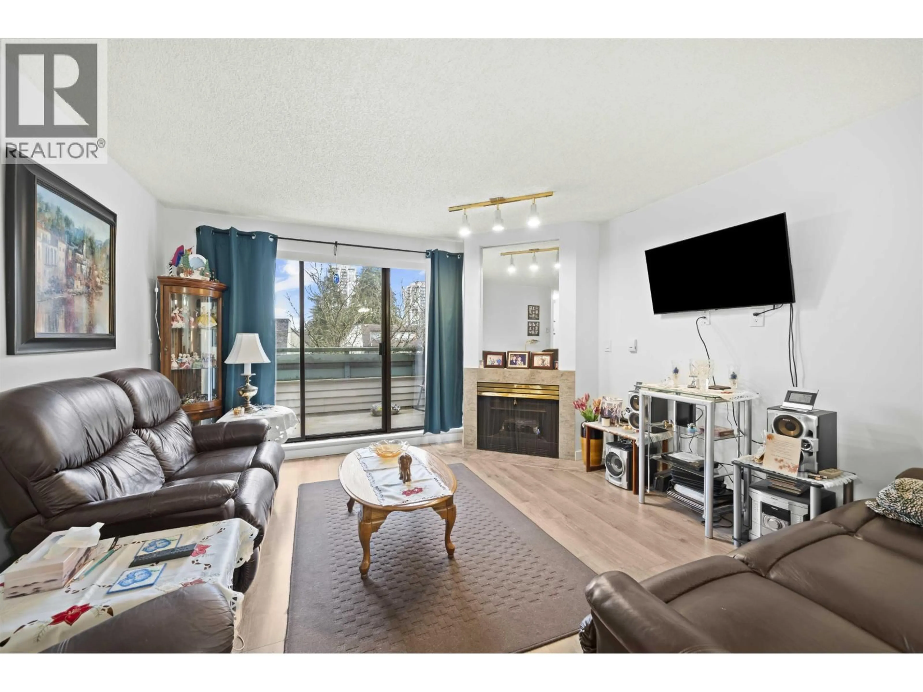 Living room with furniture, wood/laminate floor for 416 - 2915 GLEN DRIVE, Coquitlam British Columbia V3B7H8