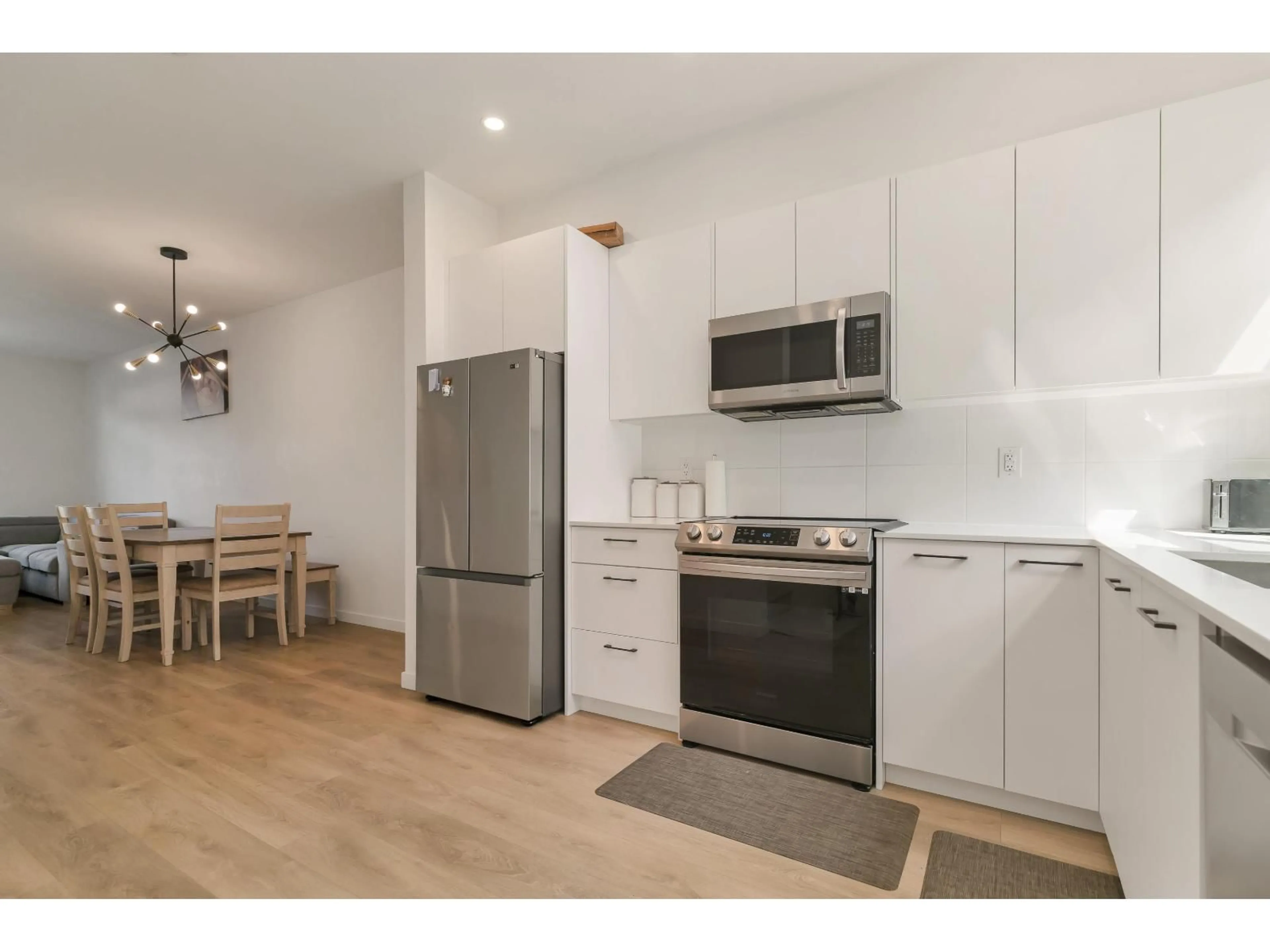 Open concept kitchen, wood/laminate floor for 99 - 15235 SITKA DRIVE, Surrey British Columbia V3S0A9