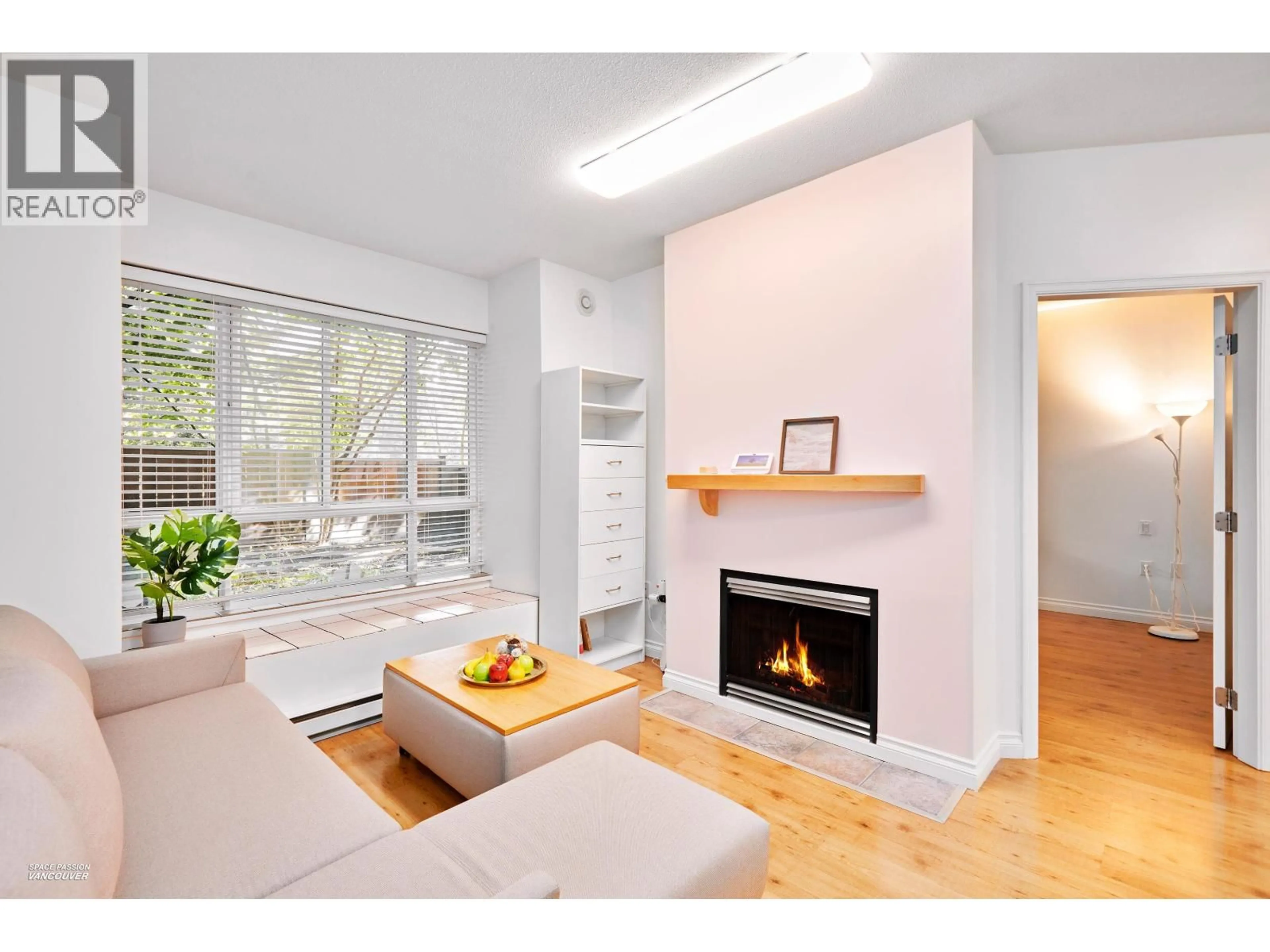 Living room with furniture, wood/laminate floor for 111 - 6833 VILLAGE, Burnaby British Columbia V5E4M1