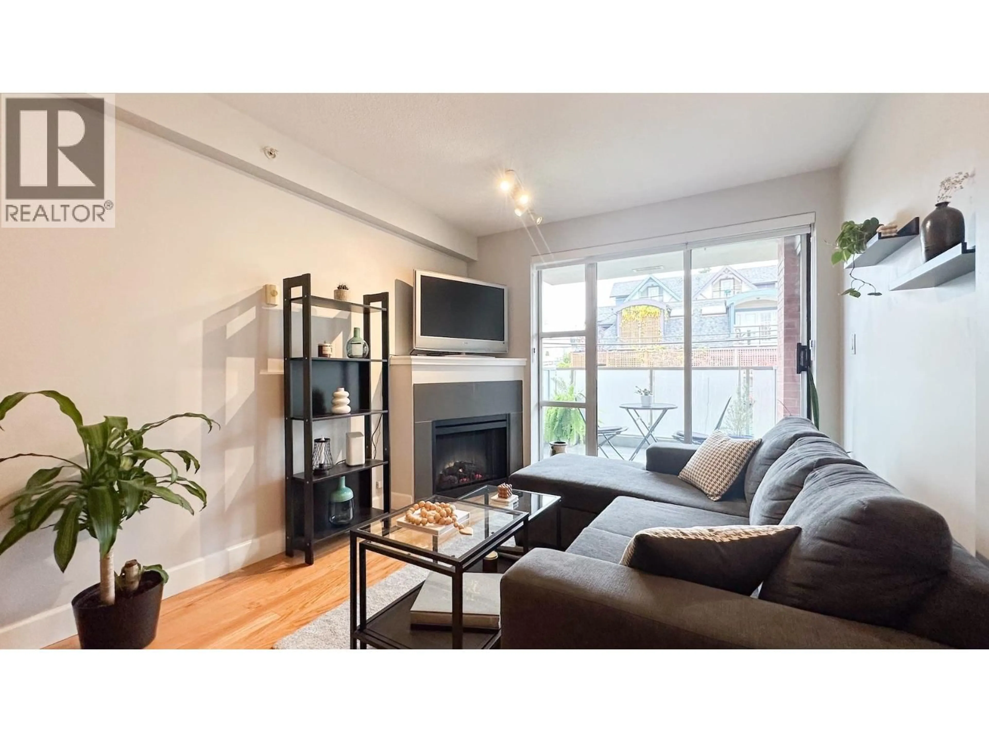 Living room with furniture, wood/laminate floor for 411 - 3811 HASTINGS STREET, Burnaby British Columbia V5C6V2