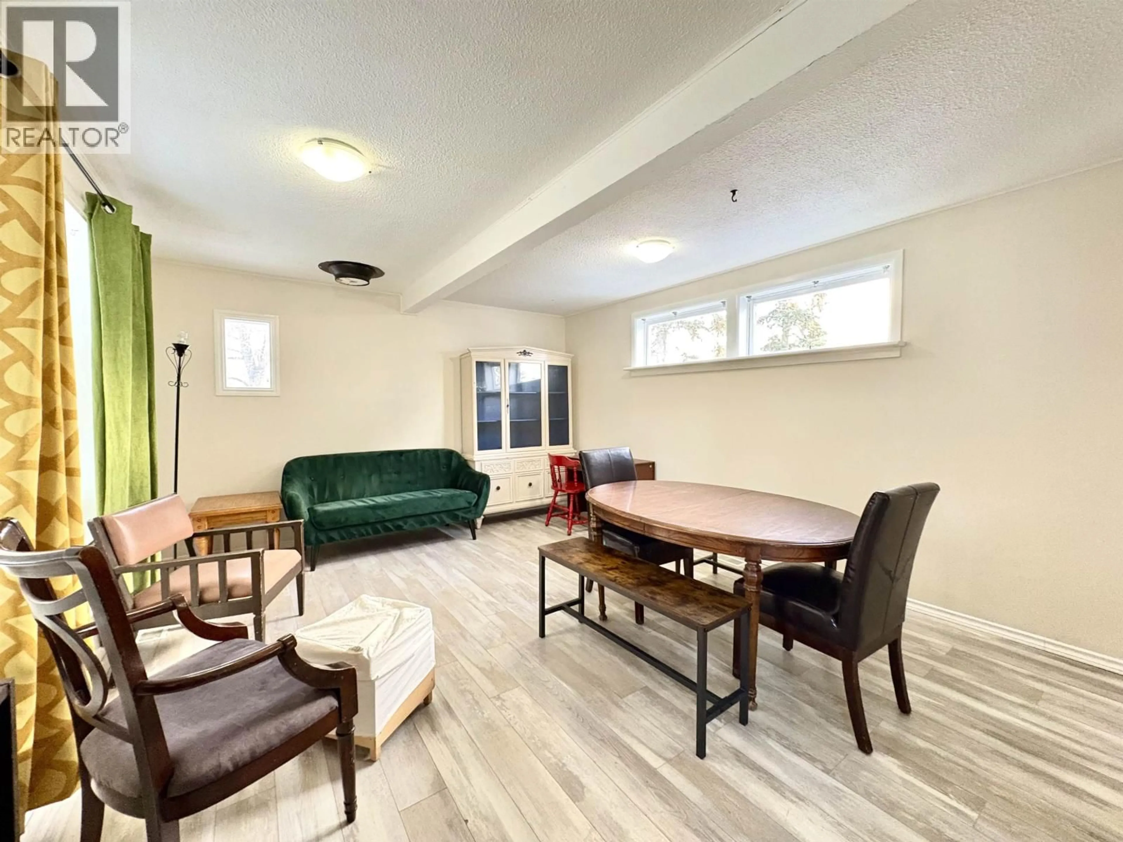 Living room with furniture, wood/laminate floor for 1909 MAPLE STREET, Prince George British Columbia V2L1X2