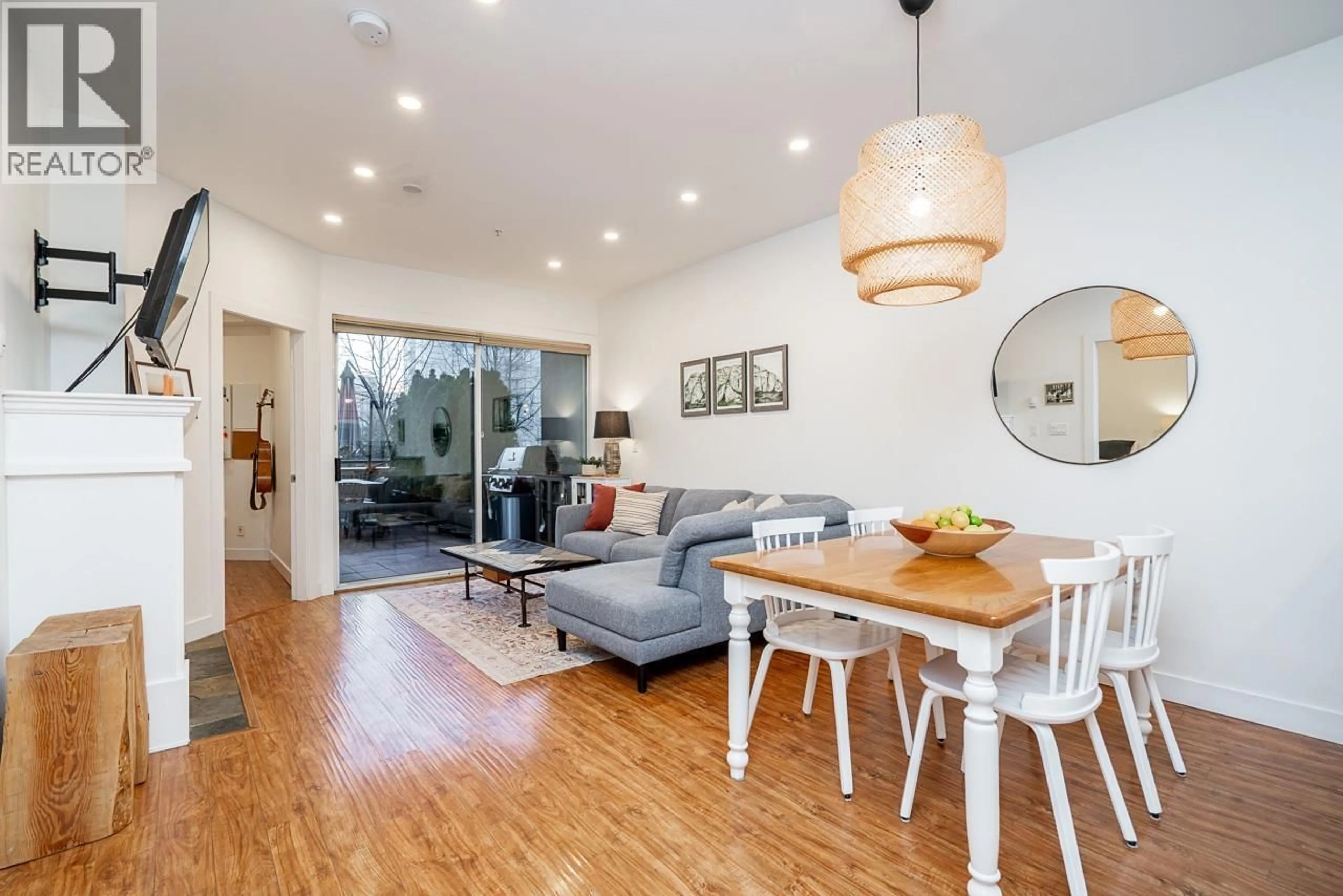 Living room with furniture, wood/laminate floor for 202 - 131 3RD STREET, North Vancouver British Columbia V7M1E7