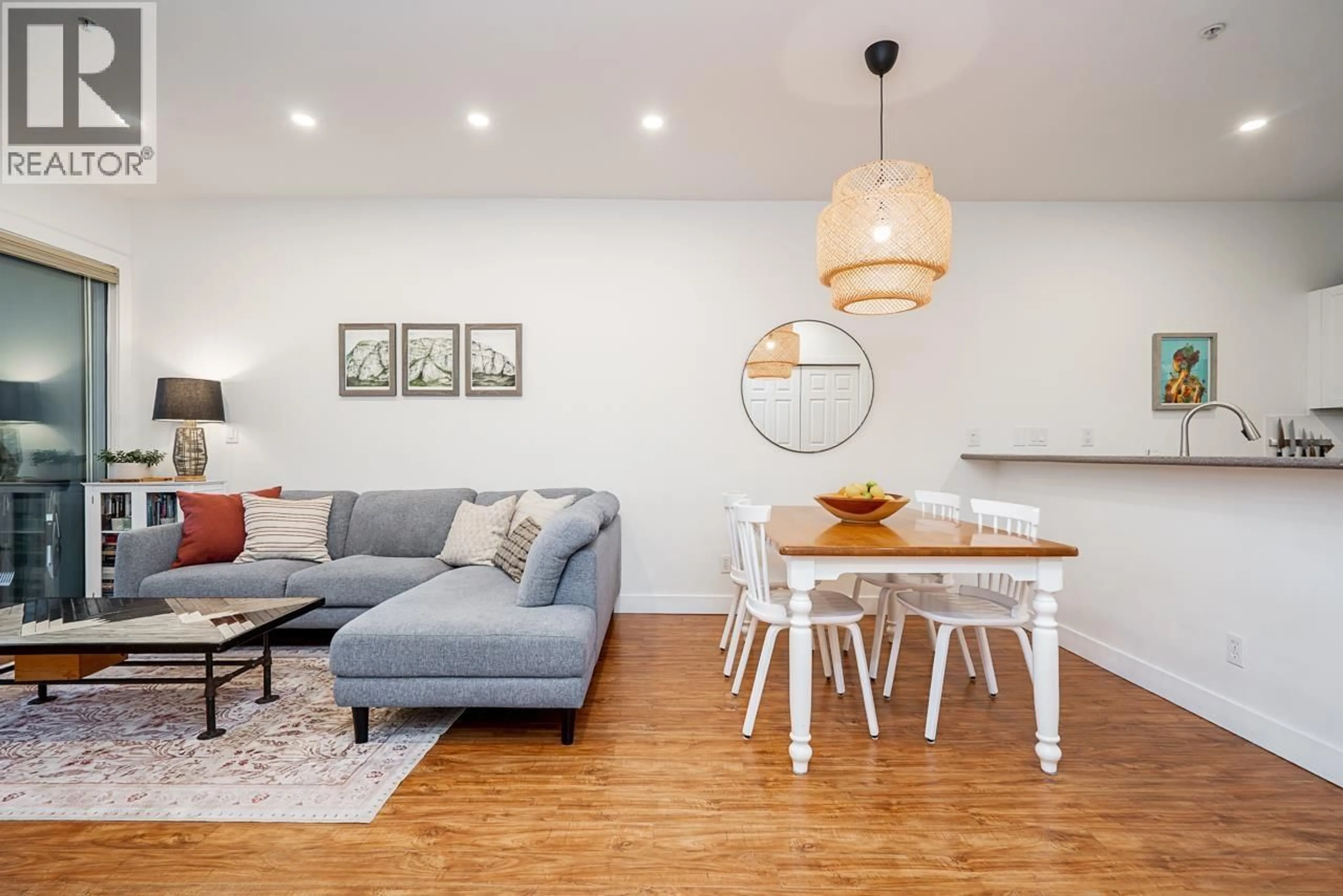 Living room with furniture, wood/laminate floor for 202 - 131 3RD STREET, North Vancouver British Columbia V7M1E7