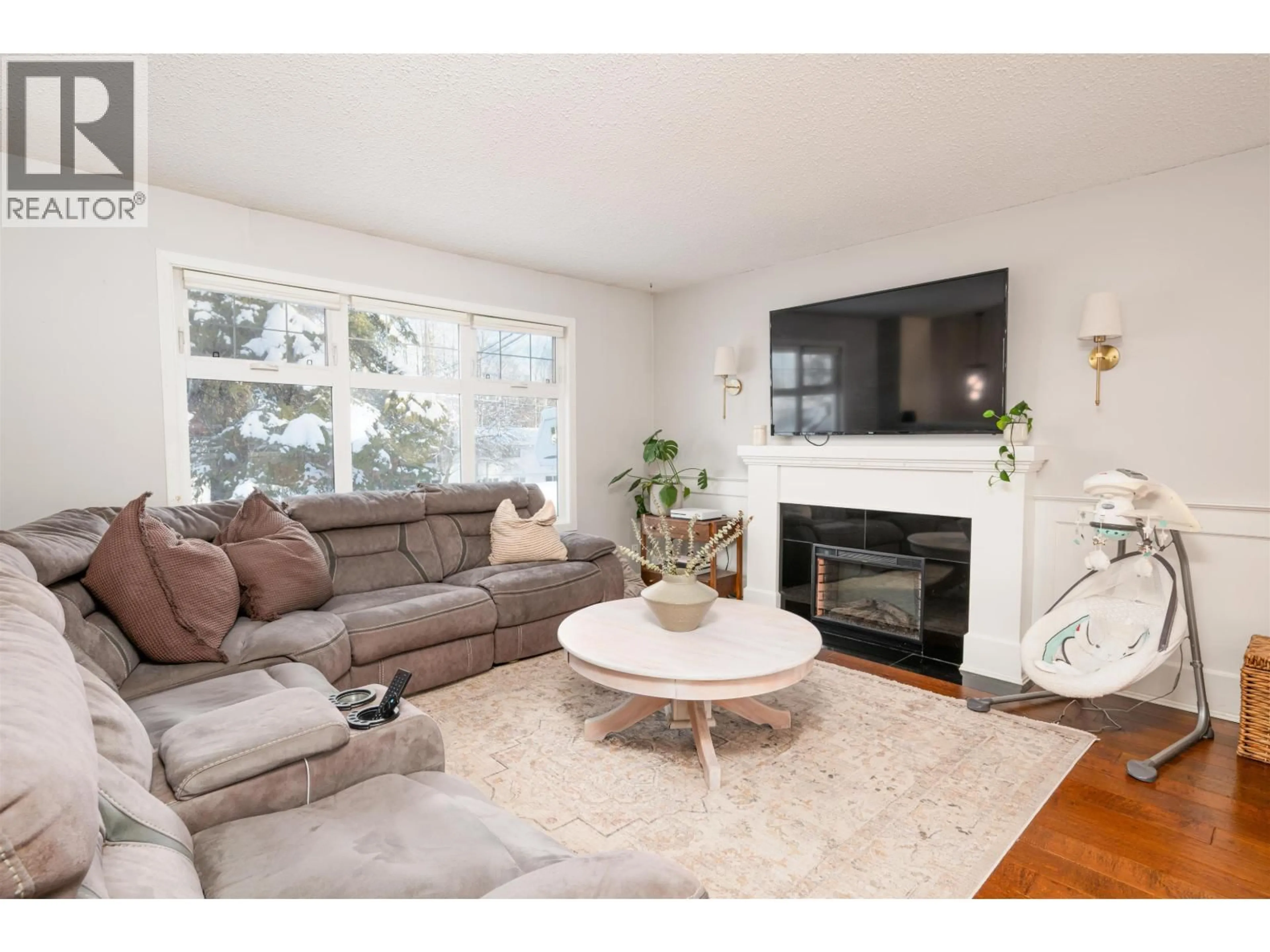 Living room with furniture, wood/laminate floor for 6777 LILAC CRESCENT, Prince George British Columbia V2K3H2