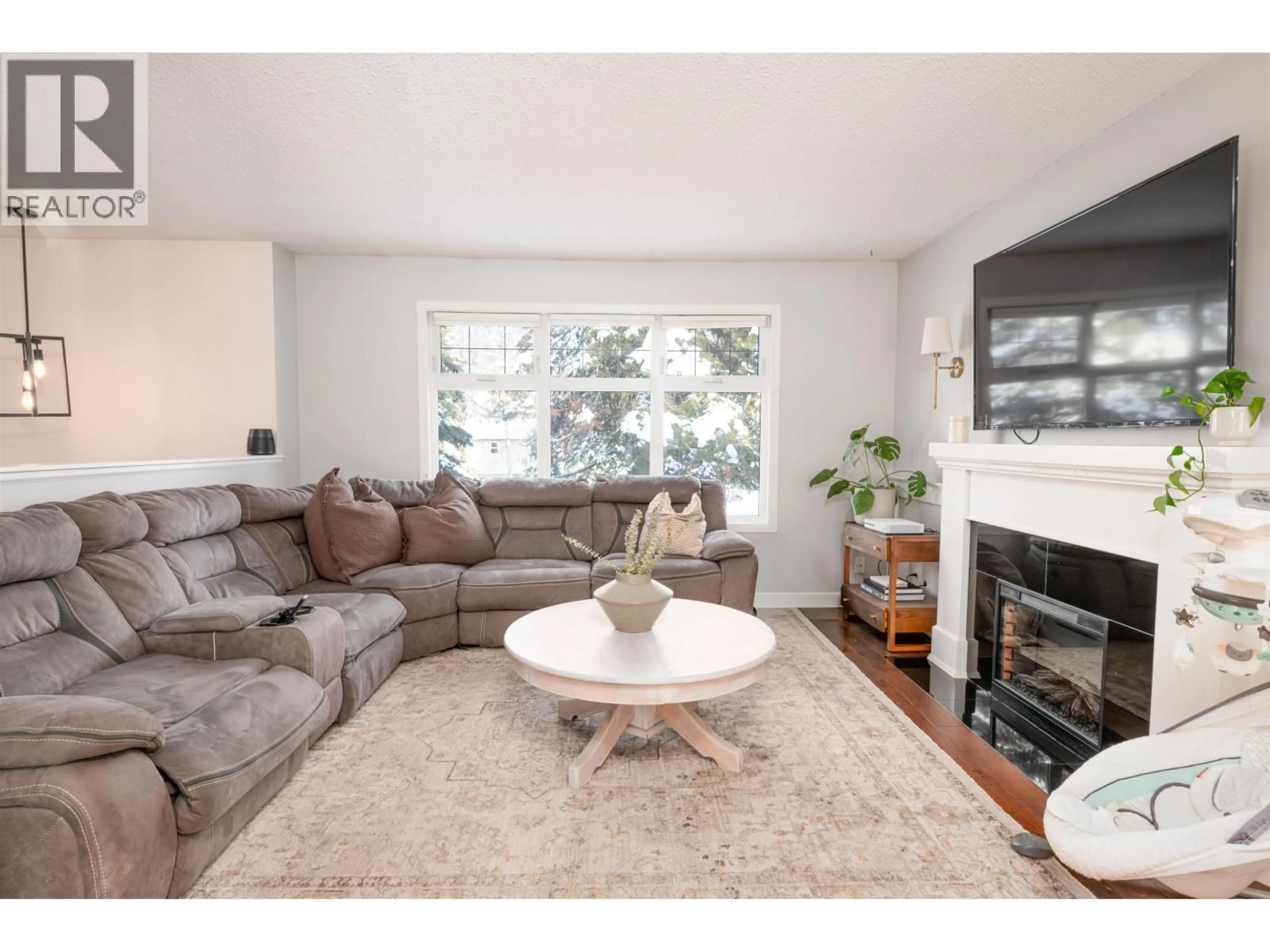 Living room with furniture, wood/laminate floor for 6777 LILAC CRESCENT, Prince George British Columbia V2K3H2