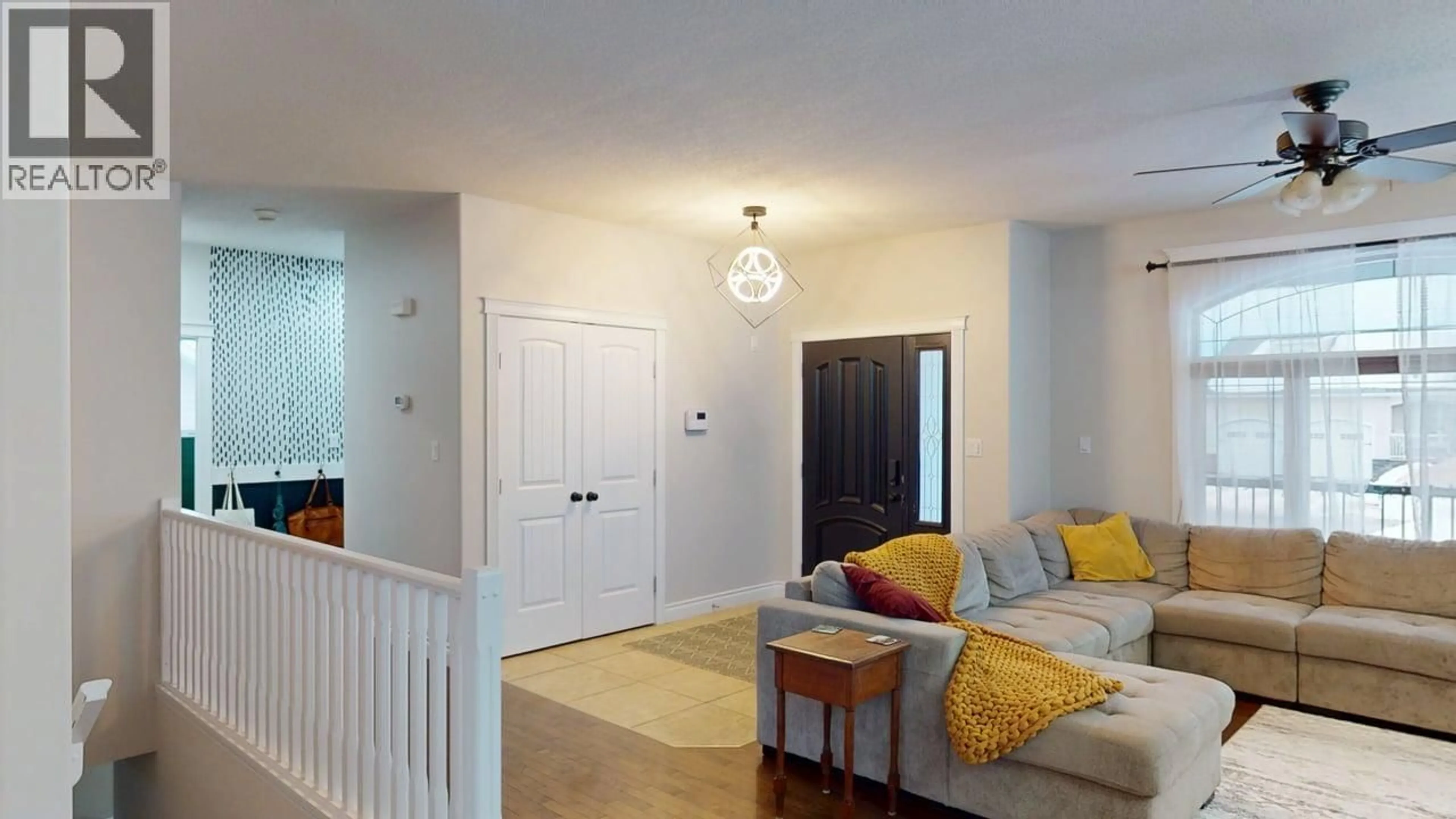 Living room with furniture, wood/laminate floor for 10503 114A AVENUE, Fort St. John British Columbia V1J0C6