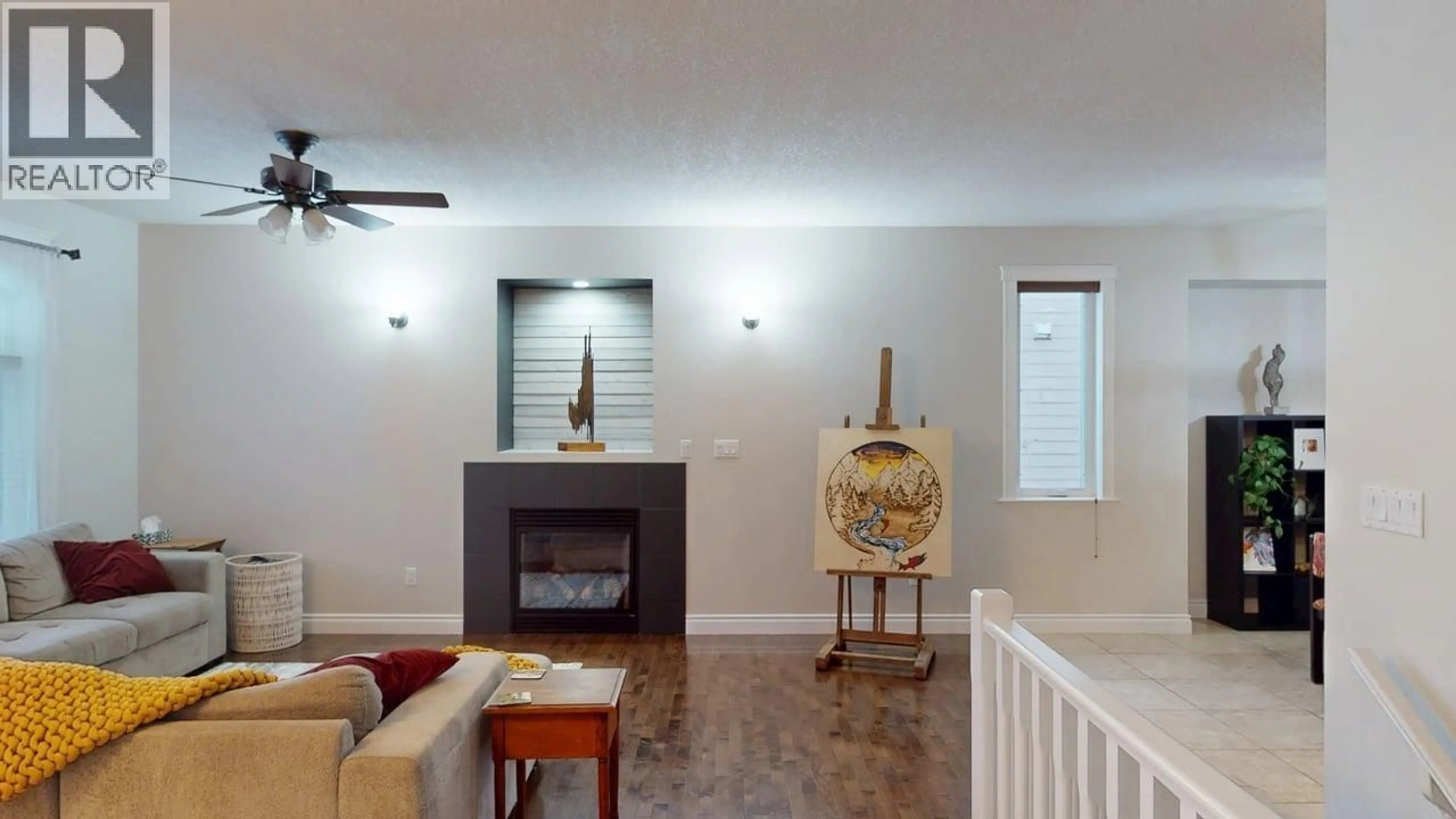 Living room with furniture, wood/laminate floor for 10503 114A AVENUE, Fort St. John British Columbia V1J0C6