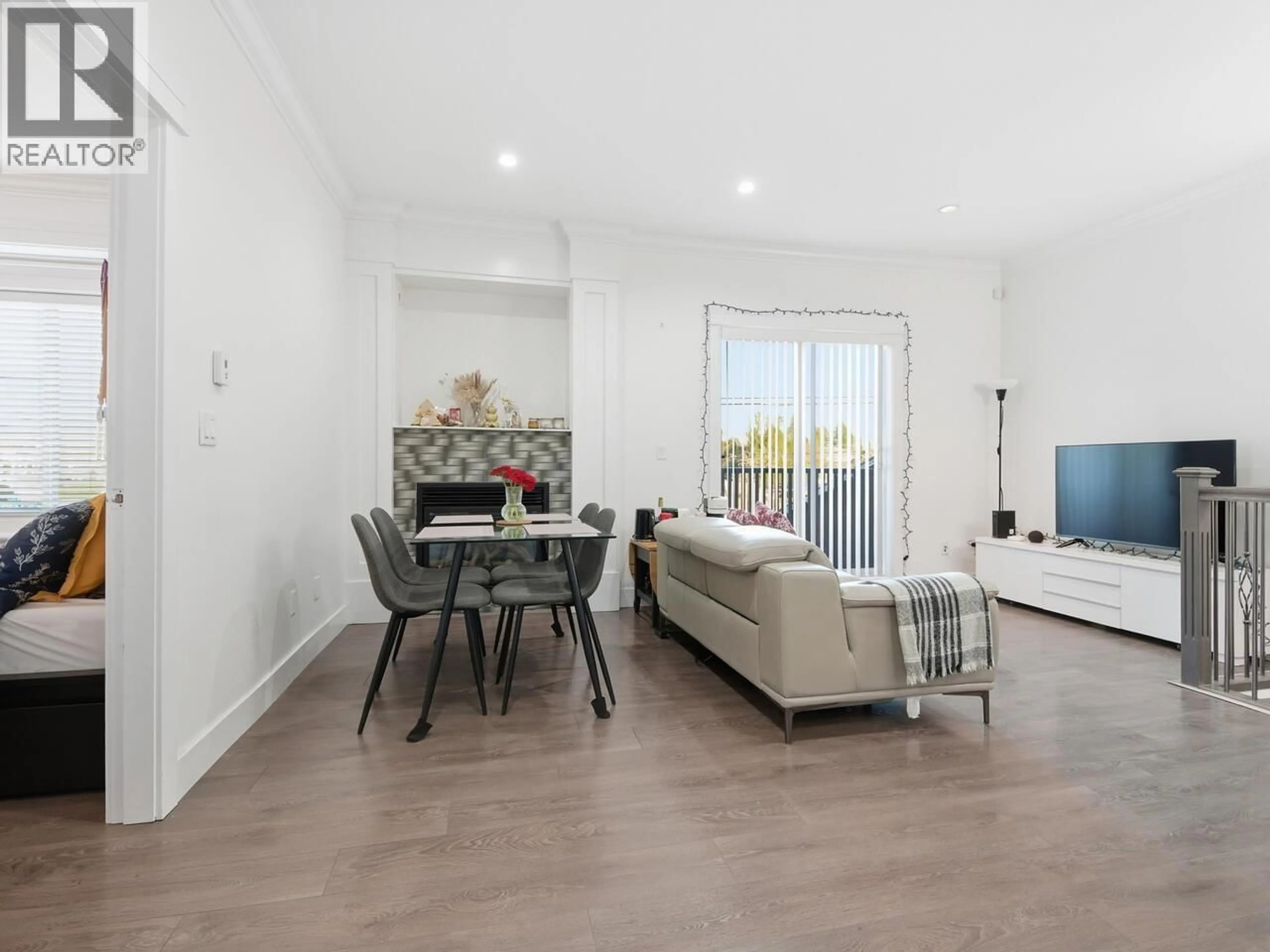 Living room with furniture, wood/laminate floor for 7847 15TH STREET, Burnaby British Columbia V3N2M7