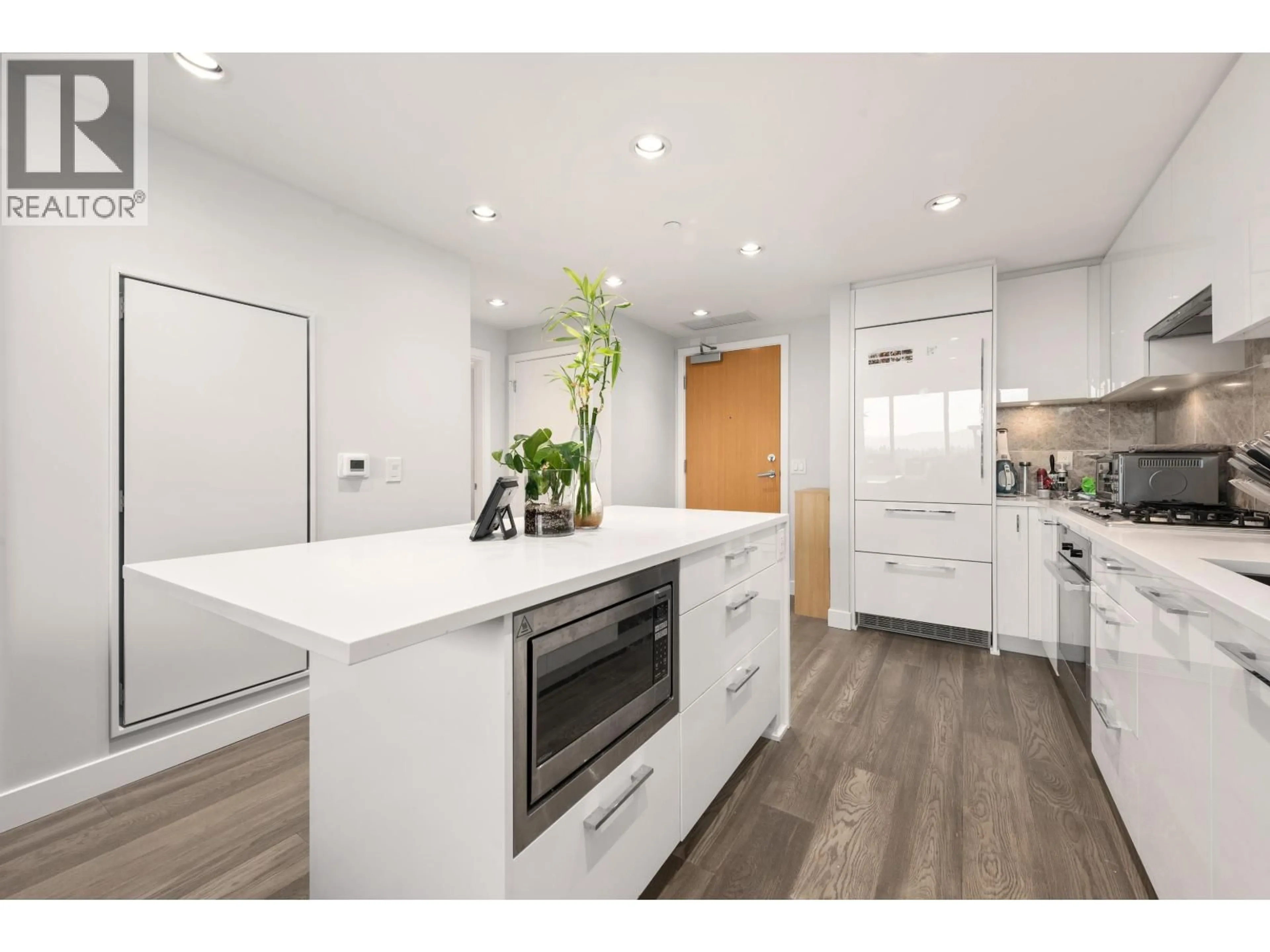 Open concept kitchen, wood/laminate floor for 1303 - 5410 SHORTCUT ROAD, Vancouver British Columbia V6T0C8
