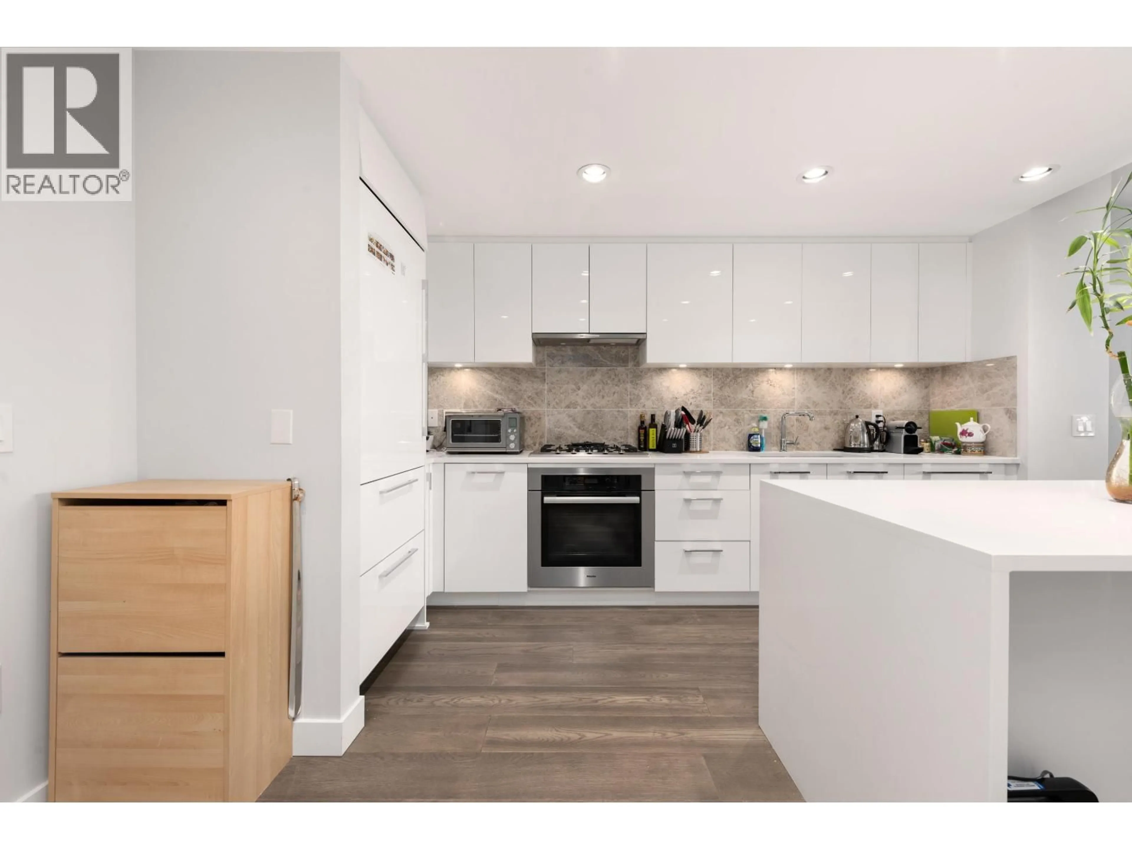 Open concept kitchen, wood/laminate floor for 1303 - 5410 SHORTCUT ROAD, Vancouver British Columbia V6T0C8