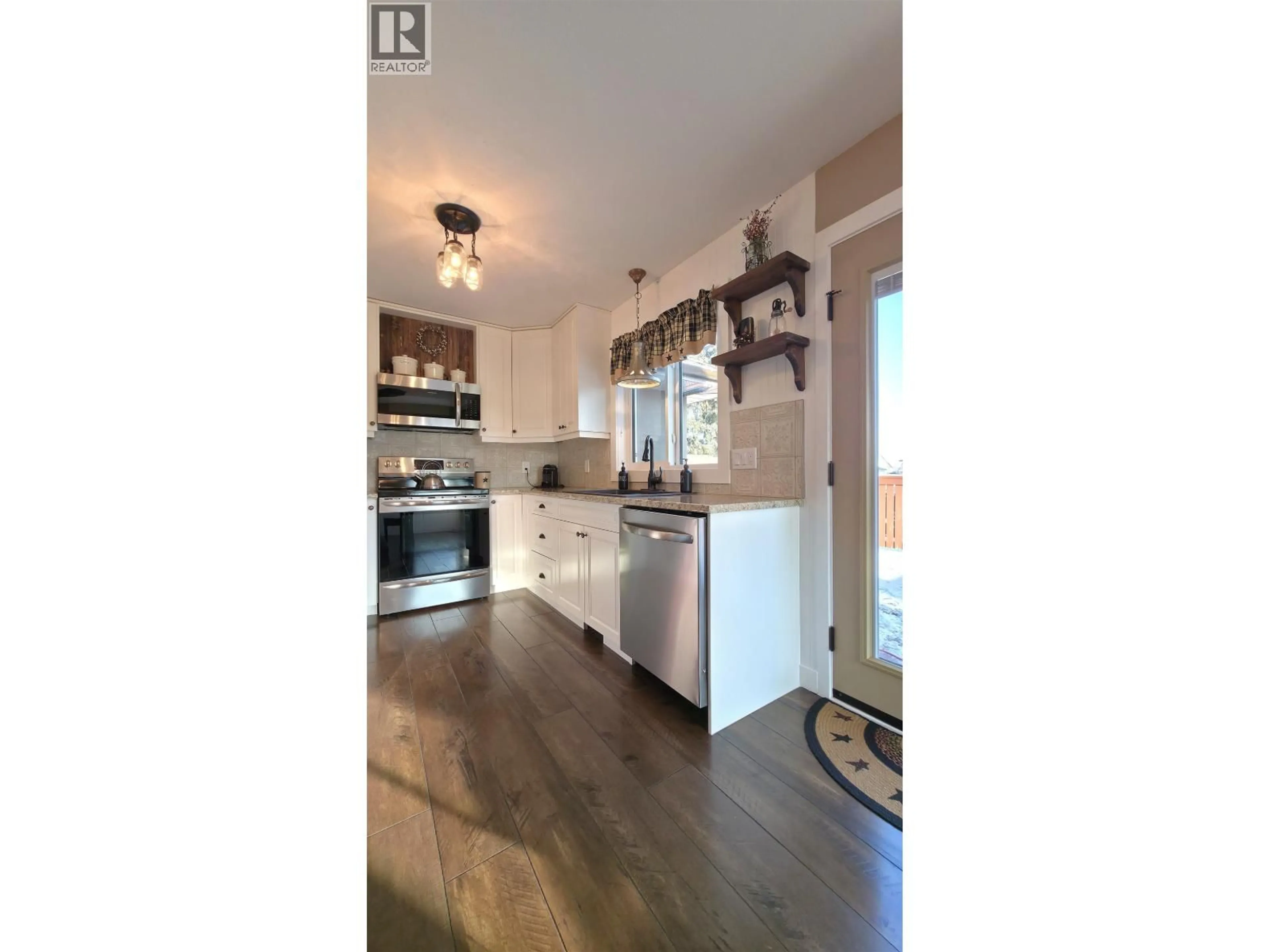 Open concept kitchen, wood/laminate floor for 6958 ST ANTHONY CRESCENT, Prince George British Columbia V2N5A2