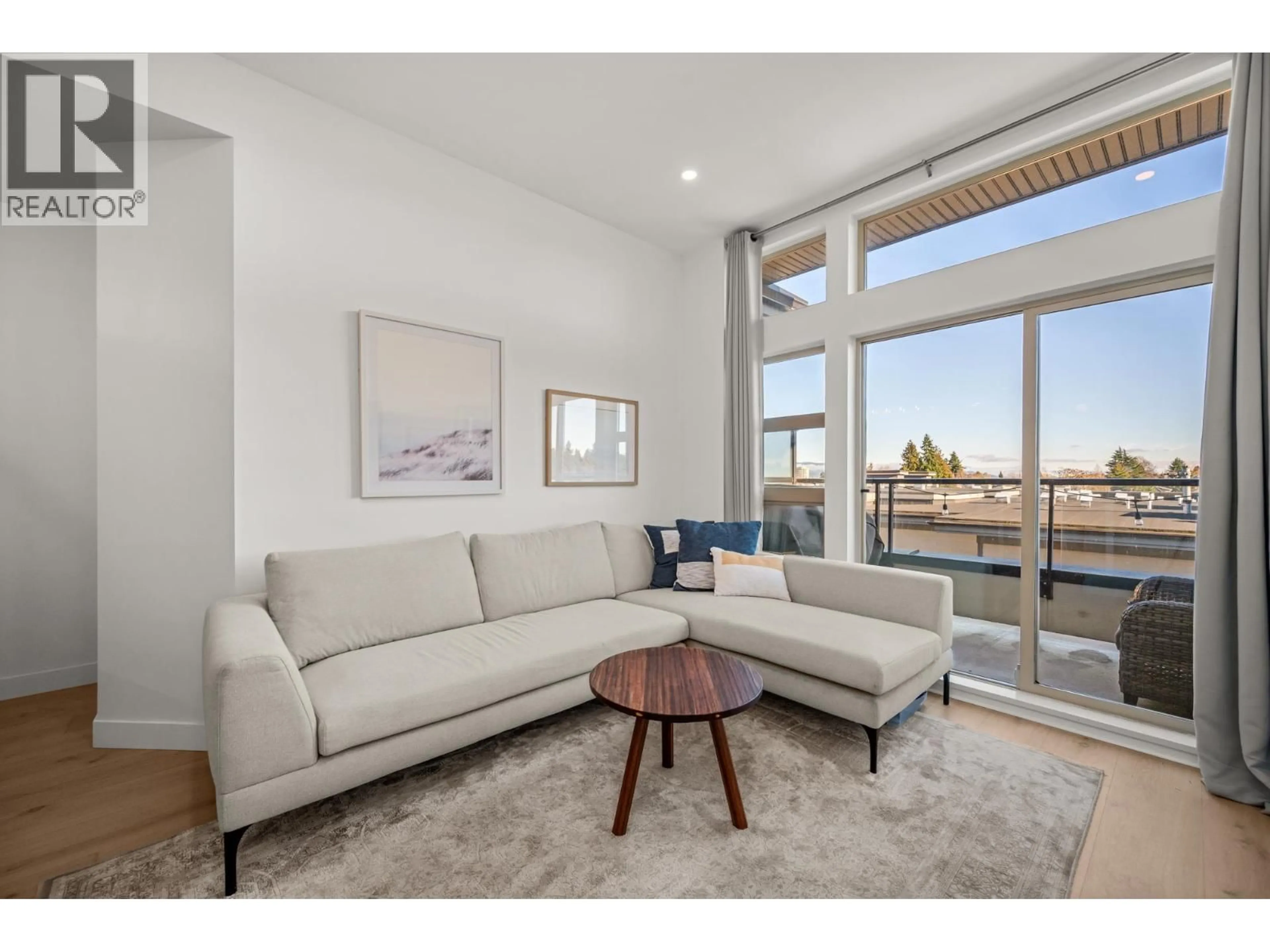 Living room with furniture, wood/laminate floor for 409 - 4550 FRASER STREET, Vancouver British Columbia V5V4G8