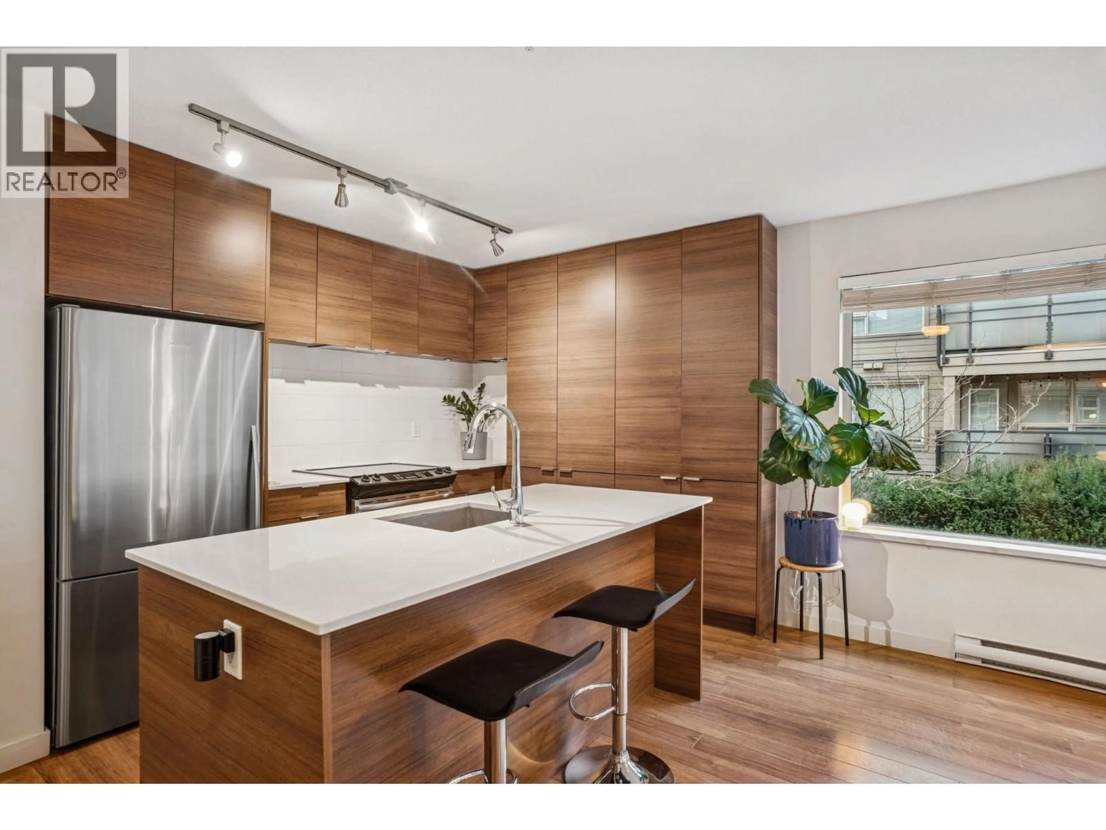 Open concept kitchen, wood/laminate floor for 310 - 1673 LLOYD AVENUE, North Vancouver British Columbia V7P0A9