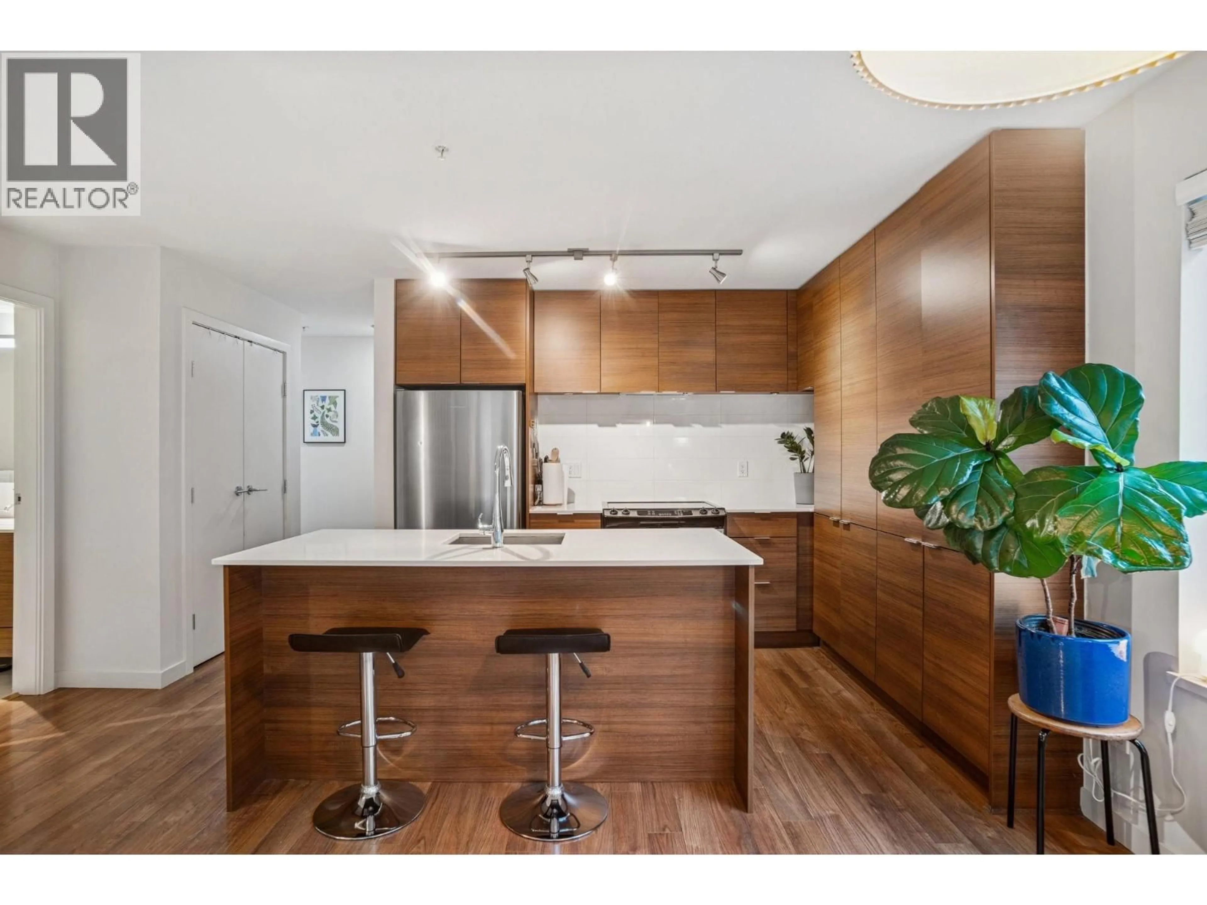Open concept kitchen, wood/laminate floor for 310 - 1673 LLOYD AVENUE, North Vancouver British Columbia V7P0A9