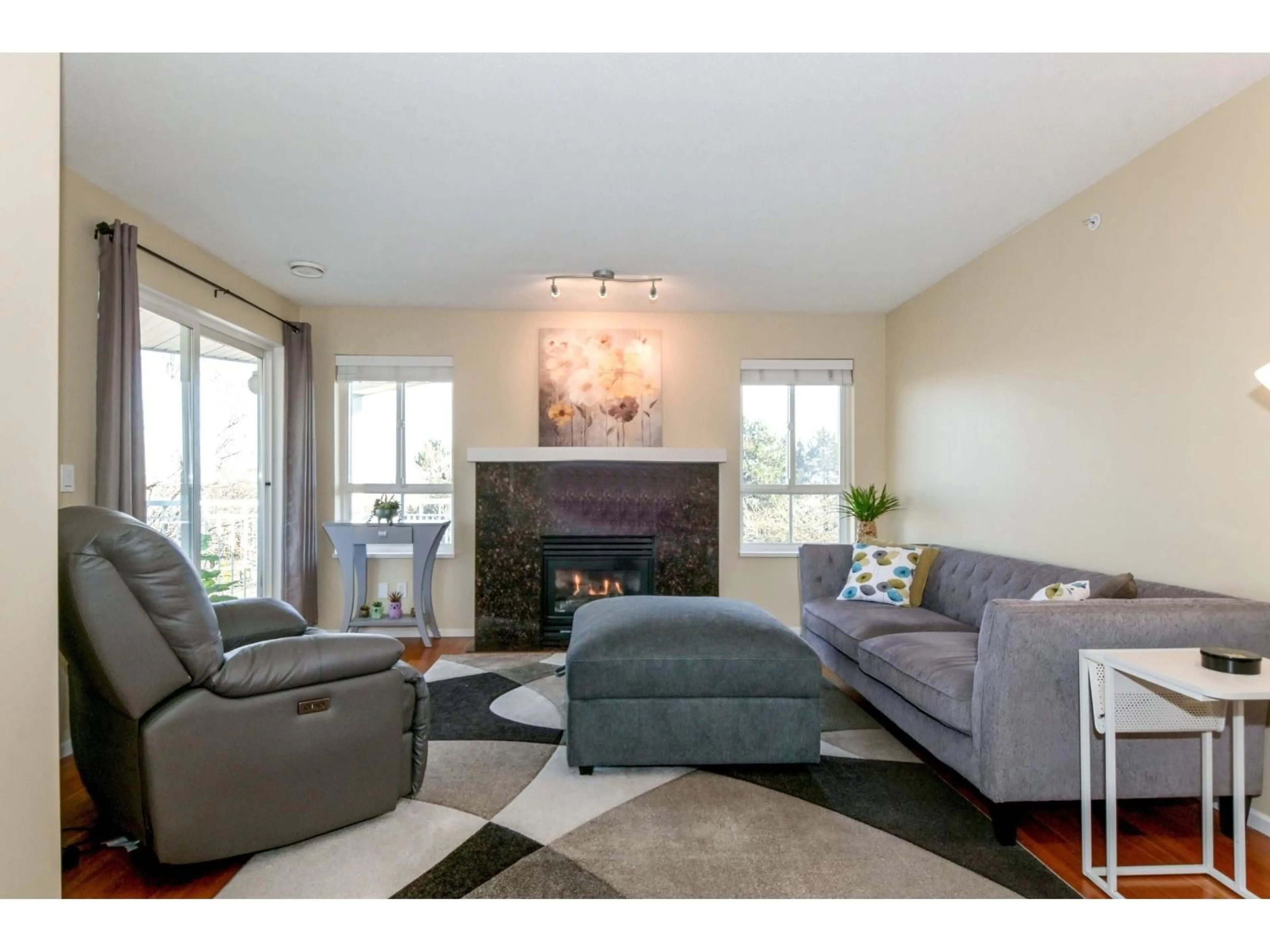 Living room with furniture, wood/laminate floor for 306 - 19750 64TH AVENUE, Langley British Columbia V2Y2T1