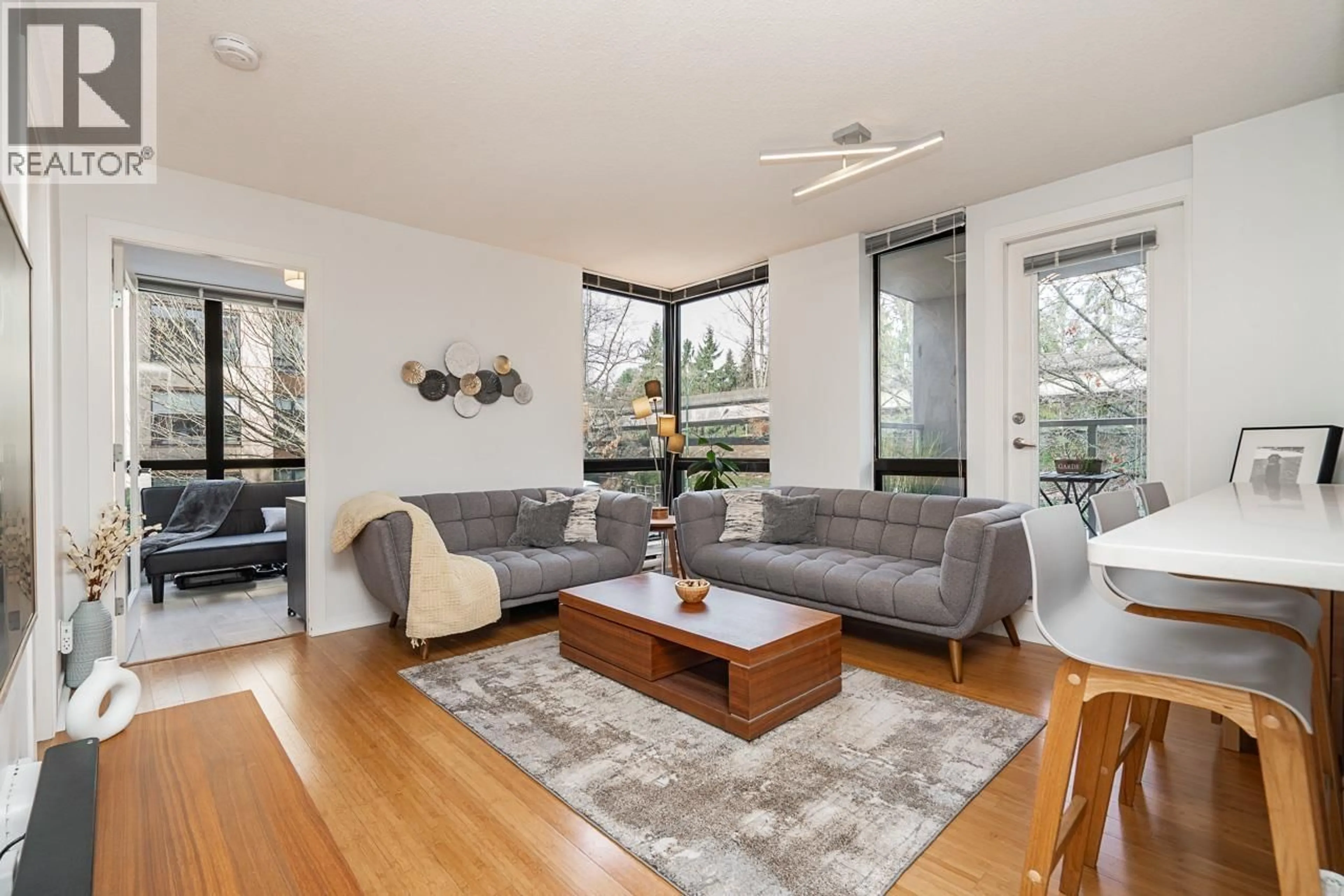 Living room with furniture, wood/laminate floor for 206 - 3638 VANNESS AVENUE, Vancouver British Columbia V5R6H6