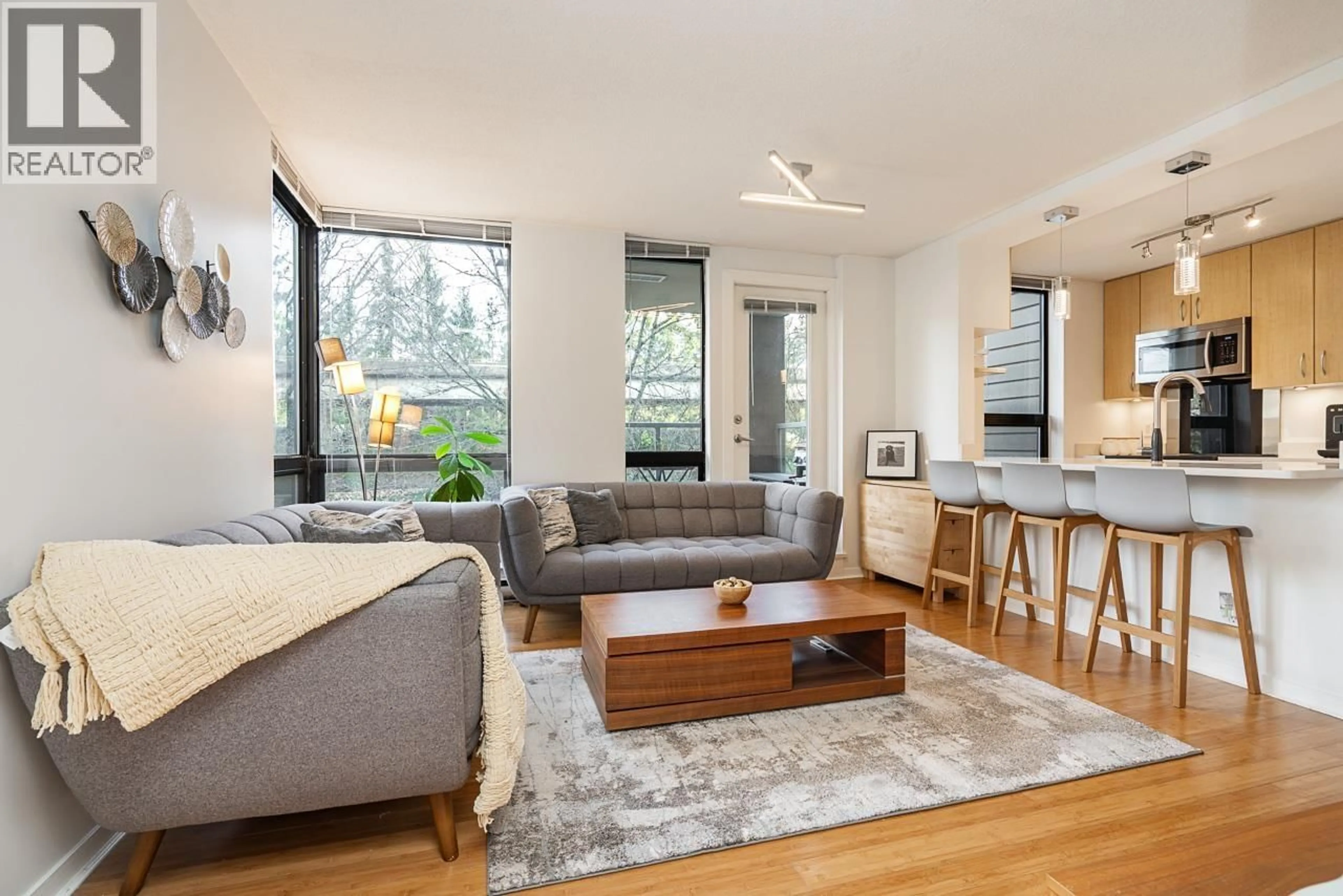 Living room with furniture, wood/laminate floor for 206 - 3638 VANNESS AVENUE, Vancouver British Columbia V5R6H6