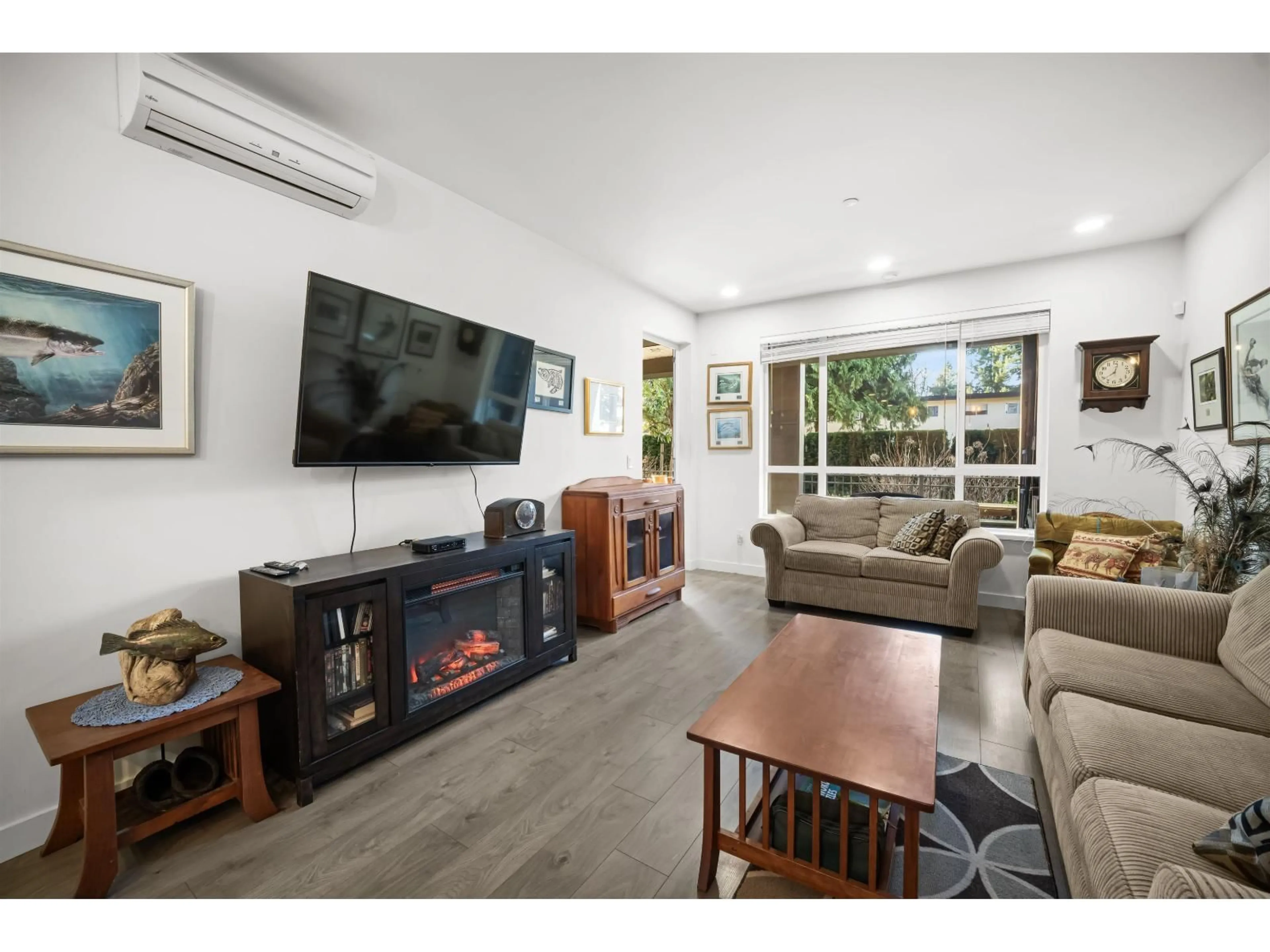 Living room with furniture, wood/laminate floor for 105 - 33540 MAYFAIR AVENUE, Abbotsford British Columbia V2S0J3